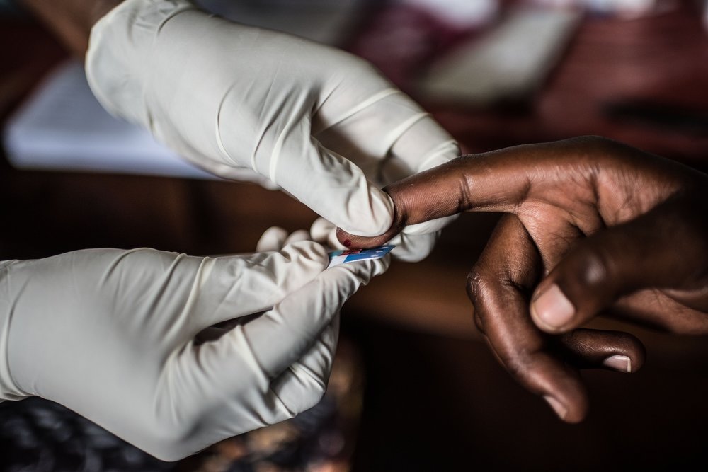  A staff member of the Jinja Regional Referral Hospital takes a blood sample for an HIV test. 