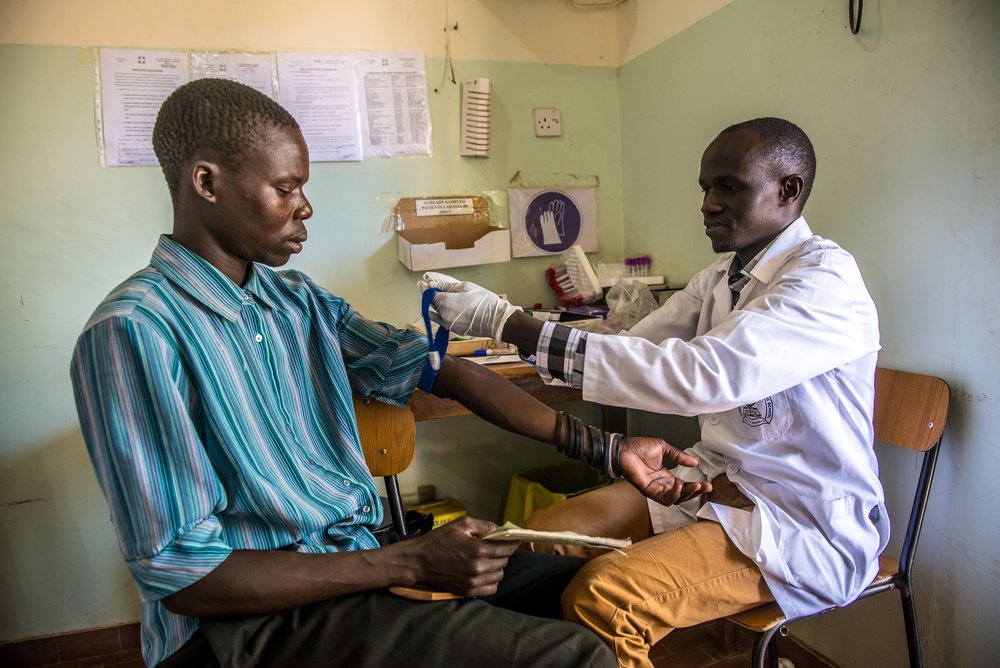  Lab Assistant David Modo takes a blood sample from a patient at the Matany hospital in Karamoja, Uganda. 