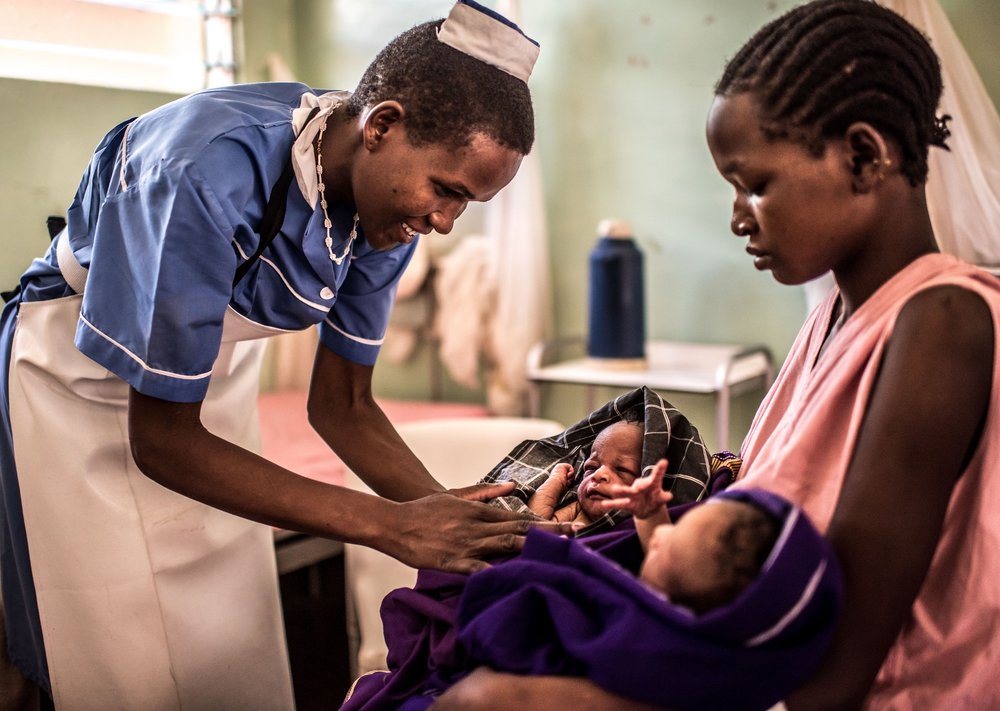  Midwife Lotukei Anna Grace interacts with Lotimong Anna, who recently gave birth to twins at the Matany hospital in Karamoja, Uganda. 