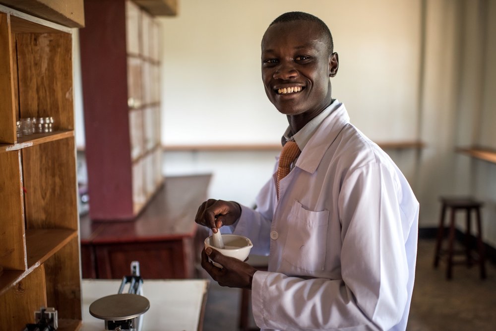  Dennis Odongo, 24, a student of the Soroti Pharmacy School, takes part in a practical excercise in the lab. 