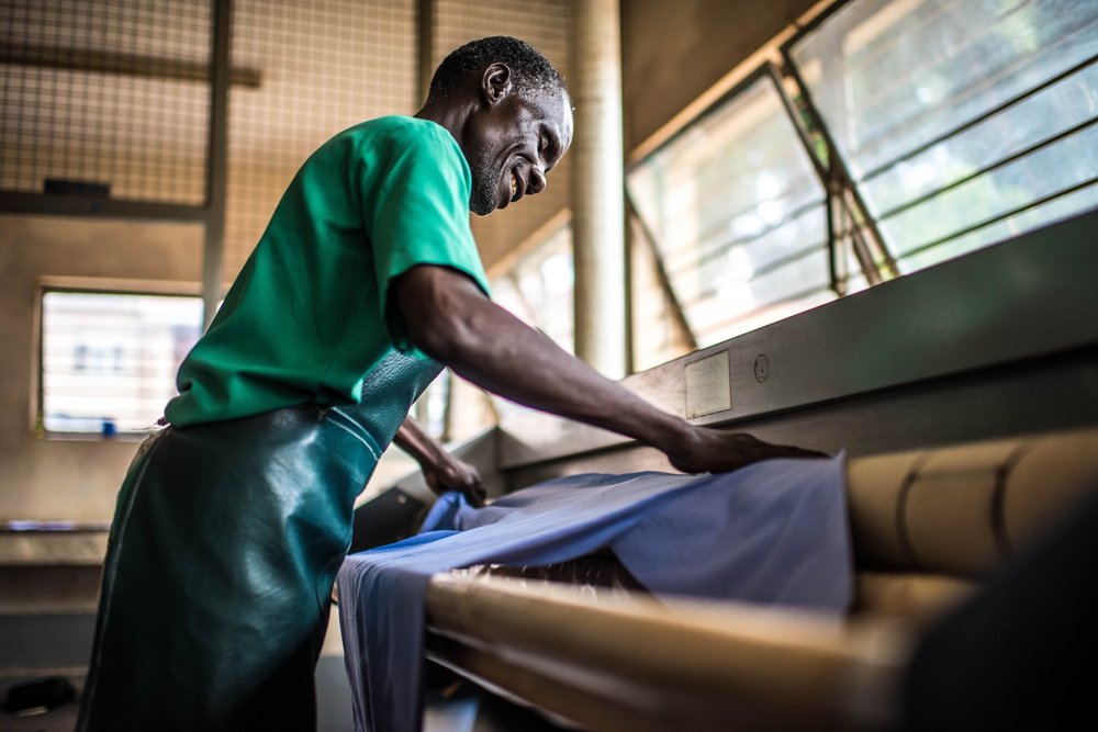  Omiat Mackay, a staff member of the Soroti Regional Referral Hospital, processes the laundry. 