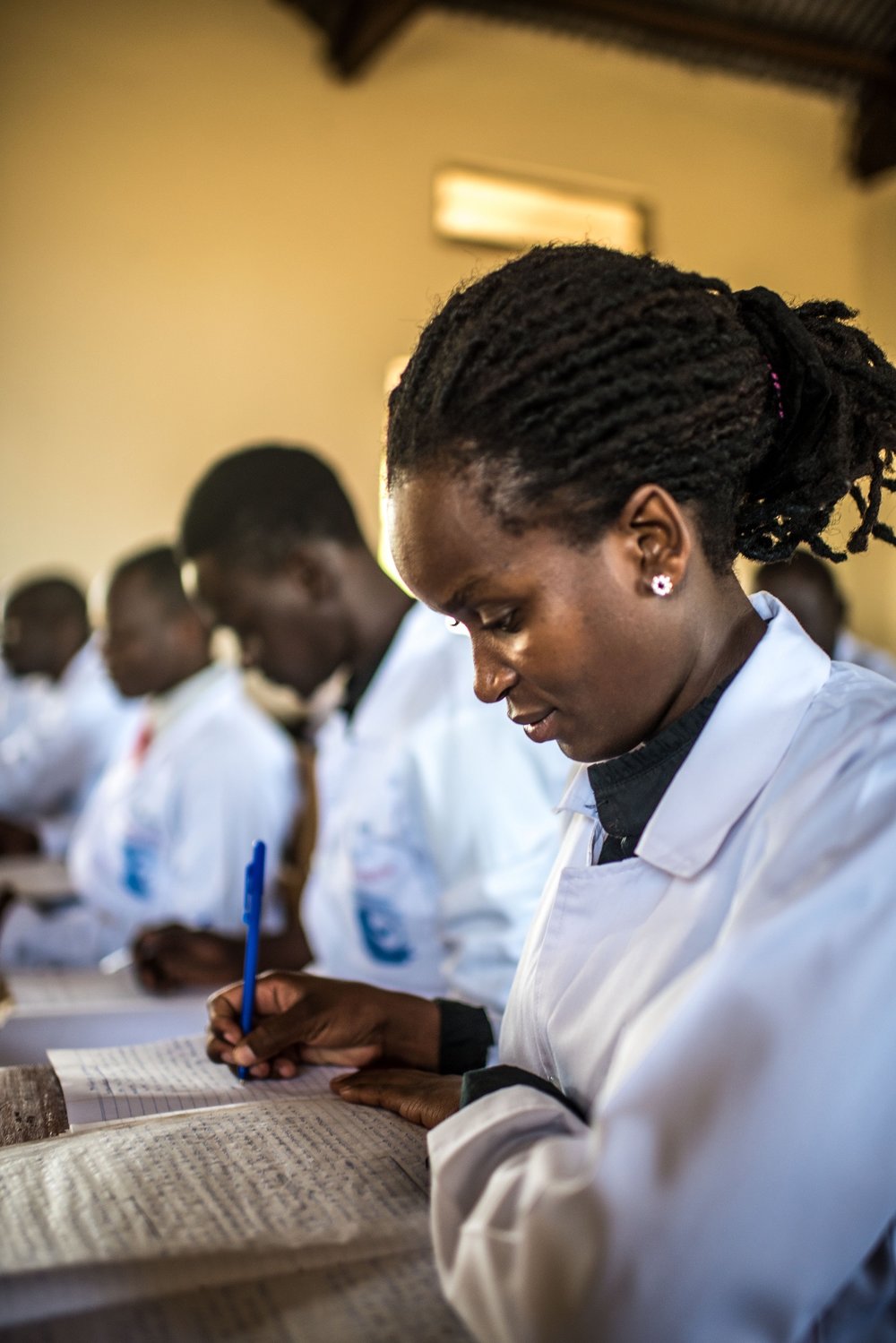  Nikiria Caoline, 21, a student of the Soroti Pharmacy School, takes notes during a class. 