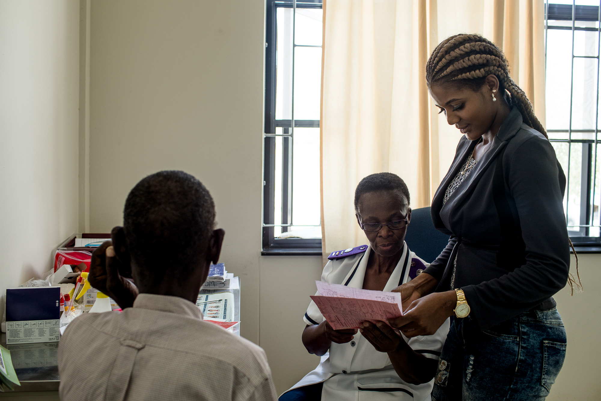 Shirley Mwellie, 69, counsels an HIV patient at Omuthiya Distric
