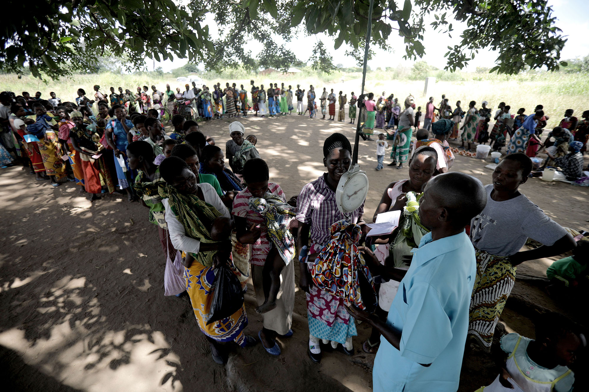  Women began to gather under the shade of a large tree in TA Nsamala, with baby’s on their backs. The program implemented by the government and supported by UNICEF is part of the “improvement of nutritional and health situation for children under 5, 