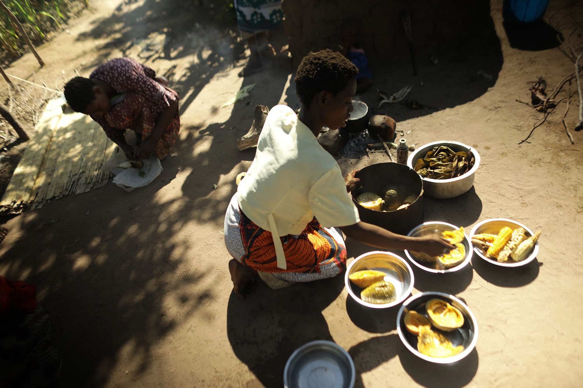  A woman prepares food near Mariam Chinguwo's house. Photo by Josh Estey 