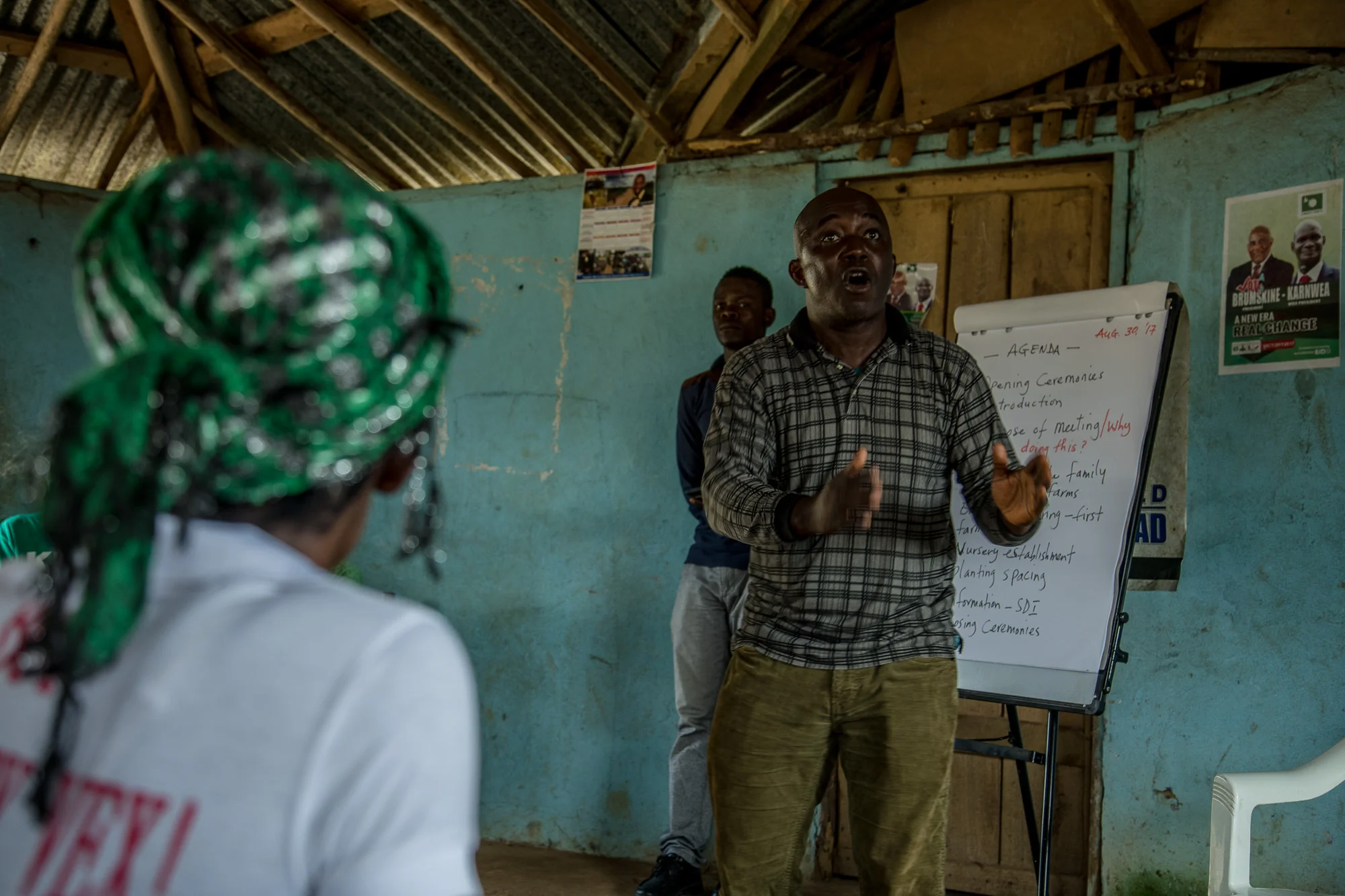 James Otto, of Sustainable Development Institute (SDI), teaches members of the Jogbahn Clan about land rights. The Jogbahn Clan fought against the British-owned company Equatorial Palm Oil (EPO) when they tried to take over their land in 2013. The people in the community depend on the land for their livelihoods. The Sustainable Development Institute (SDI) started to help the community by submitting a formal complaint to the to the Roundtable on Sustainable Palm Oil (RSPO). SDI taught the clan about land rights and resisting with non-violence. THE RSPO determined that the land EPO was using belonged to the clan. SGI trained the community how to map their land and boundaries were created that EPO accepted not to cross. Photo by Morgana Wingard