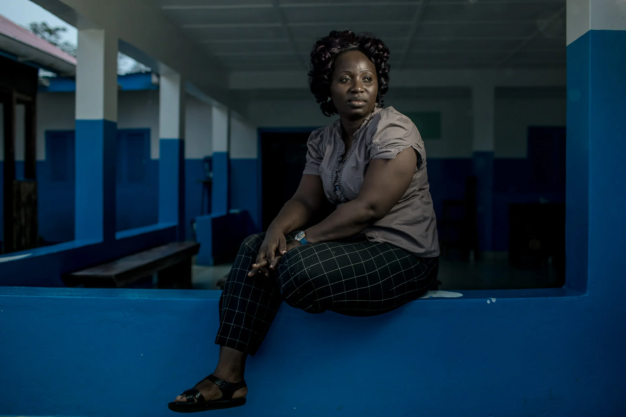 BREWERVILLE, LIBERIA: August 22, 2017 - Wislyne S. Yarh Sieh is a registered nurse at Kpallah Community Clinic in Browerville—just outside of Monrovia, Liberia. She was a healthcare worker during the Ebola outbreak in 2014-2015. During that time there was no centralized system for the Ministry of Health to communicate to all healthcare workers across the country at the same time. UNICEF and USAID teamed up to create a platform that utilized mobile phones to facilitate a two way communication system between healthcare workers and the centralized ministry. Now Wislyne receives text messages on her phone with vital information when there is a health emergency. She can also use her phone to send important information like the status of supply stocks in the clinic. Photo by Morgana Wingard