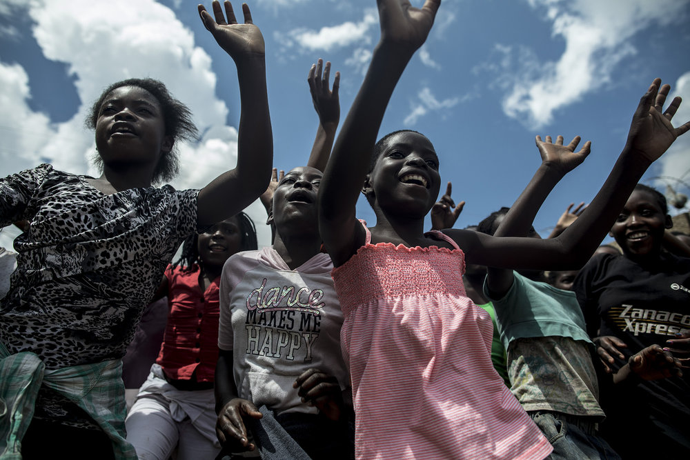  LUSAKA, ZAMBIA: Feb. 22, 2018 - A group of girls, who all participate in the UNFPA Youth Safe-Space Center program, dance and sing while saying goodbye to the CARE Learning Tour to Zambia delegation at the center.&nbsp;Photo by Sarah Grile. 