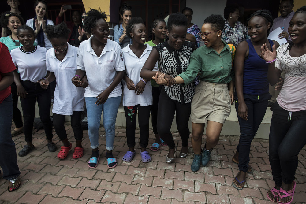  LUSAKA, ZAMBIA: Feb. 19, 2018 - Mia R. Keeys, third from right, Health Policy Advisor to Congresswoman Robin Kelly (D-IL), dances with girls from the DREAMS Center and other CARE Learning Tour to Zambia delegation members after touring the center's 