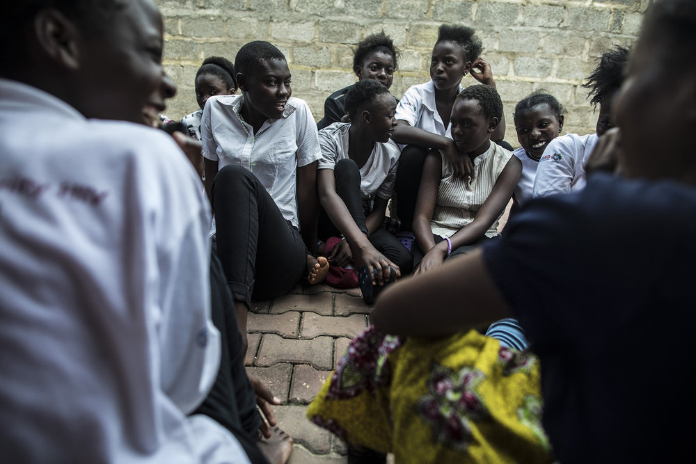  LUSAKA, ZAMBIA: Feb. 19, 2018 - Members of the DREAMS Center program hang out outside the center after meeting with the CARE Learning Tour to Zambia delegation.&nbsp;Photo by Sarah Grile. 