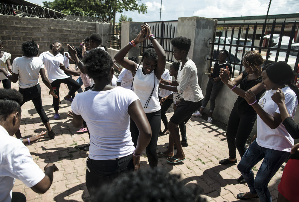  LUSAKA, ZAMBIA: Feb. 19, 2018 - Participants of the DREAMS Center in Lusaka dance for the CARE Learning Tour to Zambia delegation at the center on Feb. 19, 2018.&nbsp;Photo by Sarah Grile. 