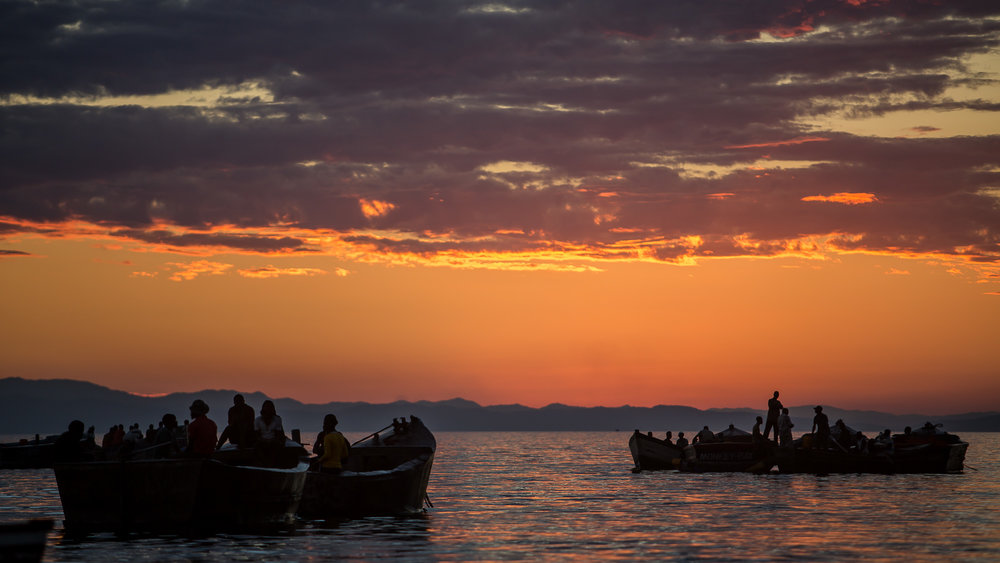 Fisherman in Masaka Bay prepare their boats for the nights fishi