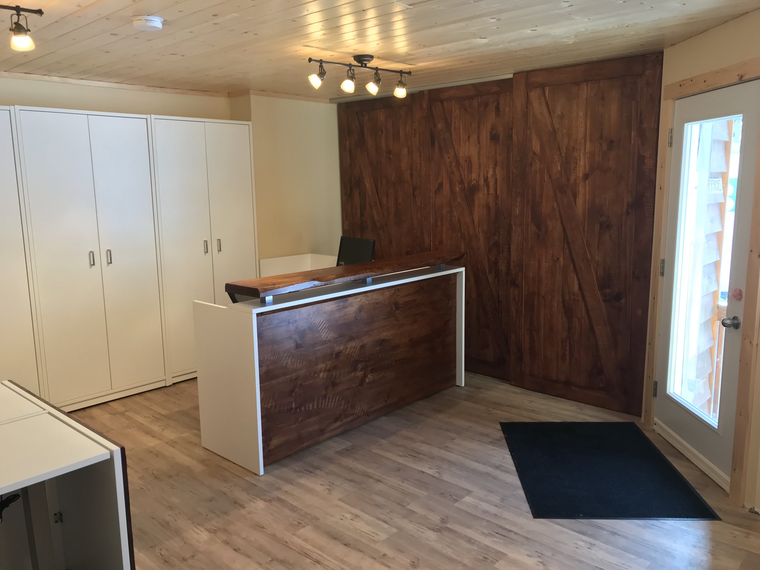  Our new reception desk, with some great barn doors hiding the electrical panels we couldn't completely cover. The great thing about this desk (and the new front door) is that we can now see right down the camp road for those arriving at camp, so we 