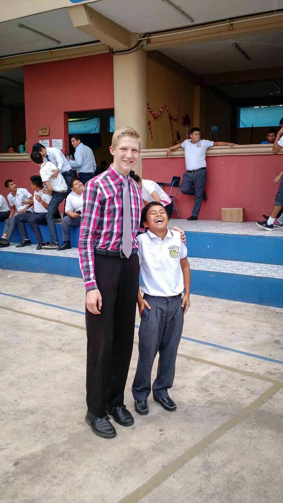 Silas and a new friend after our concert at this boy's school.