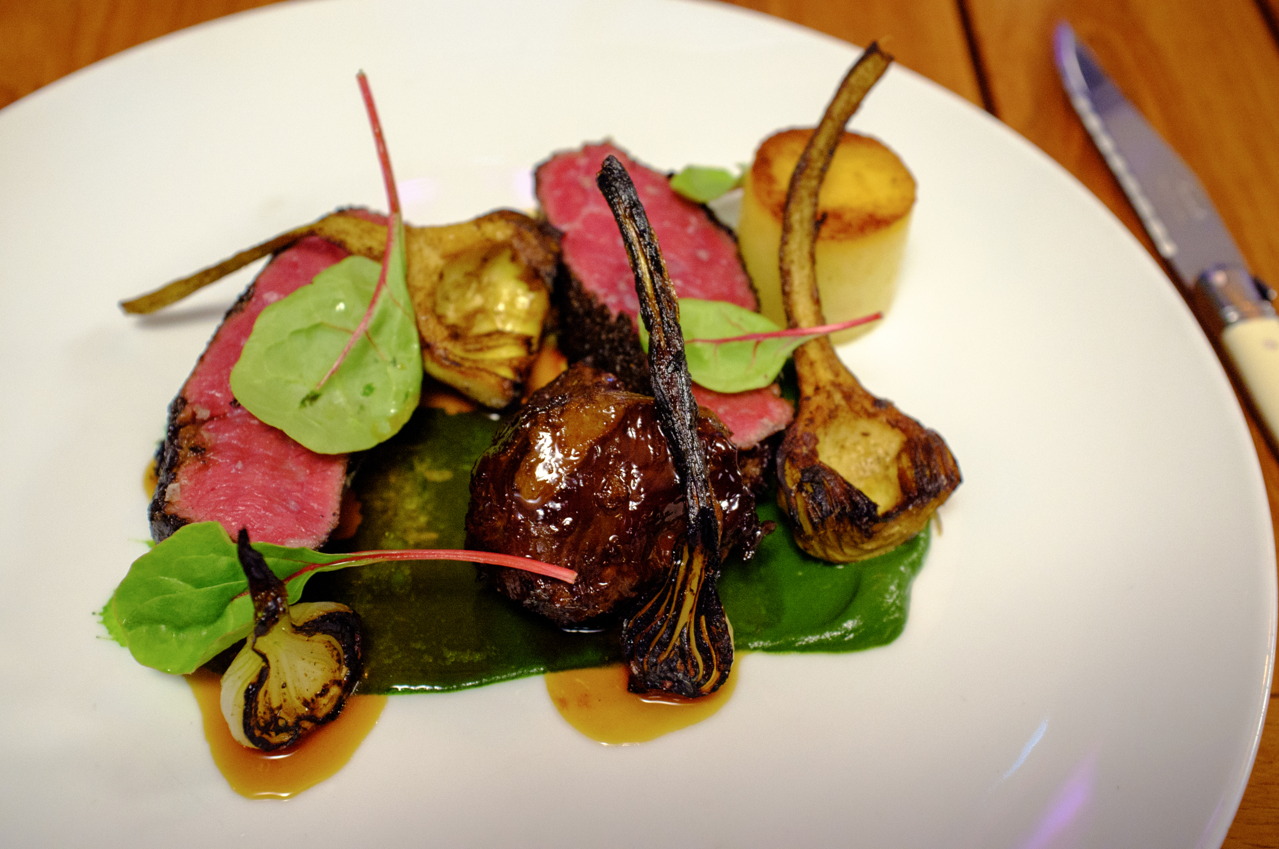 Wagyu sirloin and cheek with burnt onion, baby artichoke and watercress and roquette purée