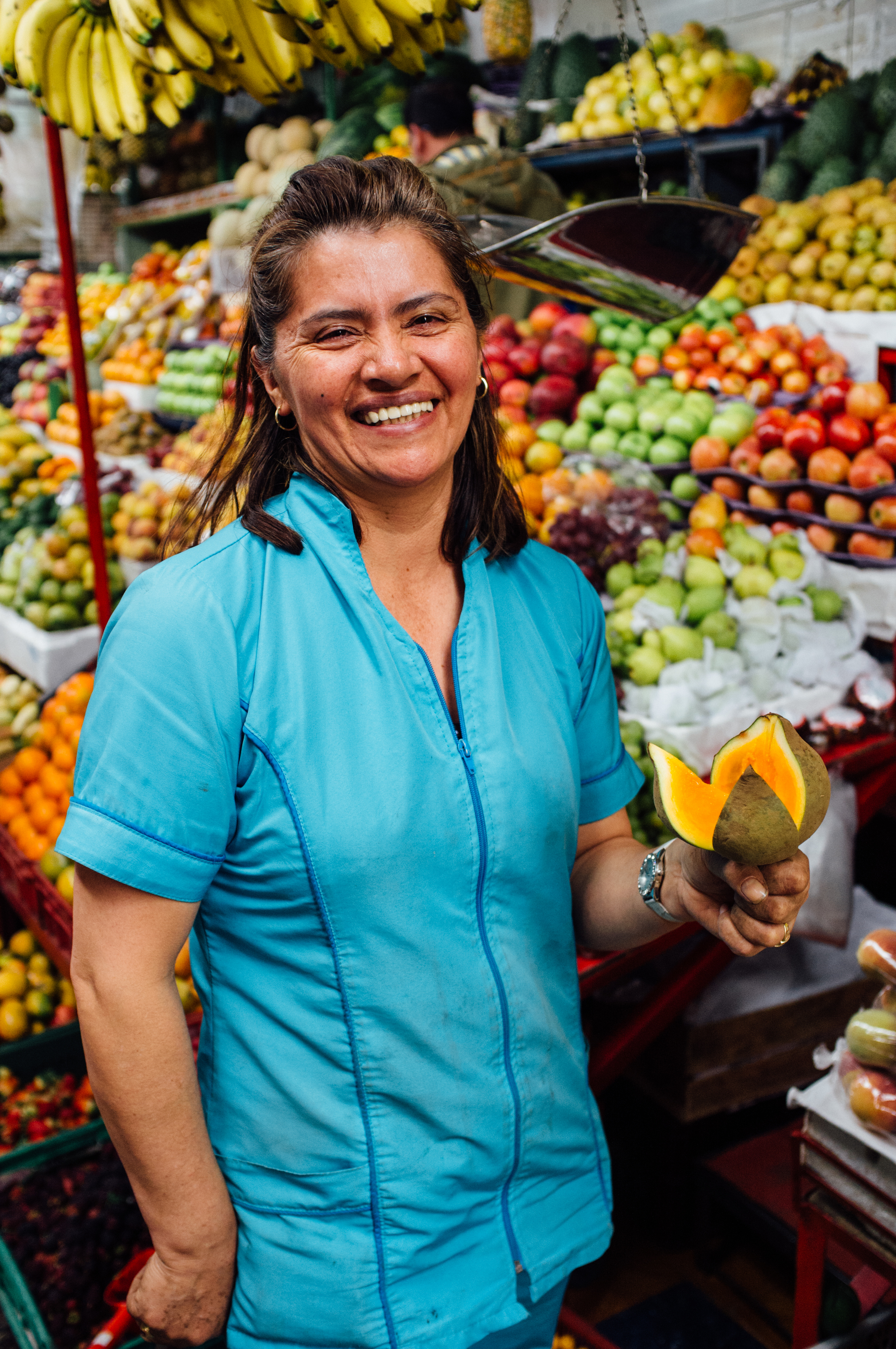 Chatica, a vendor at the Mercado de Paloquemao, modeling a níspero for us