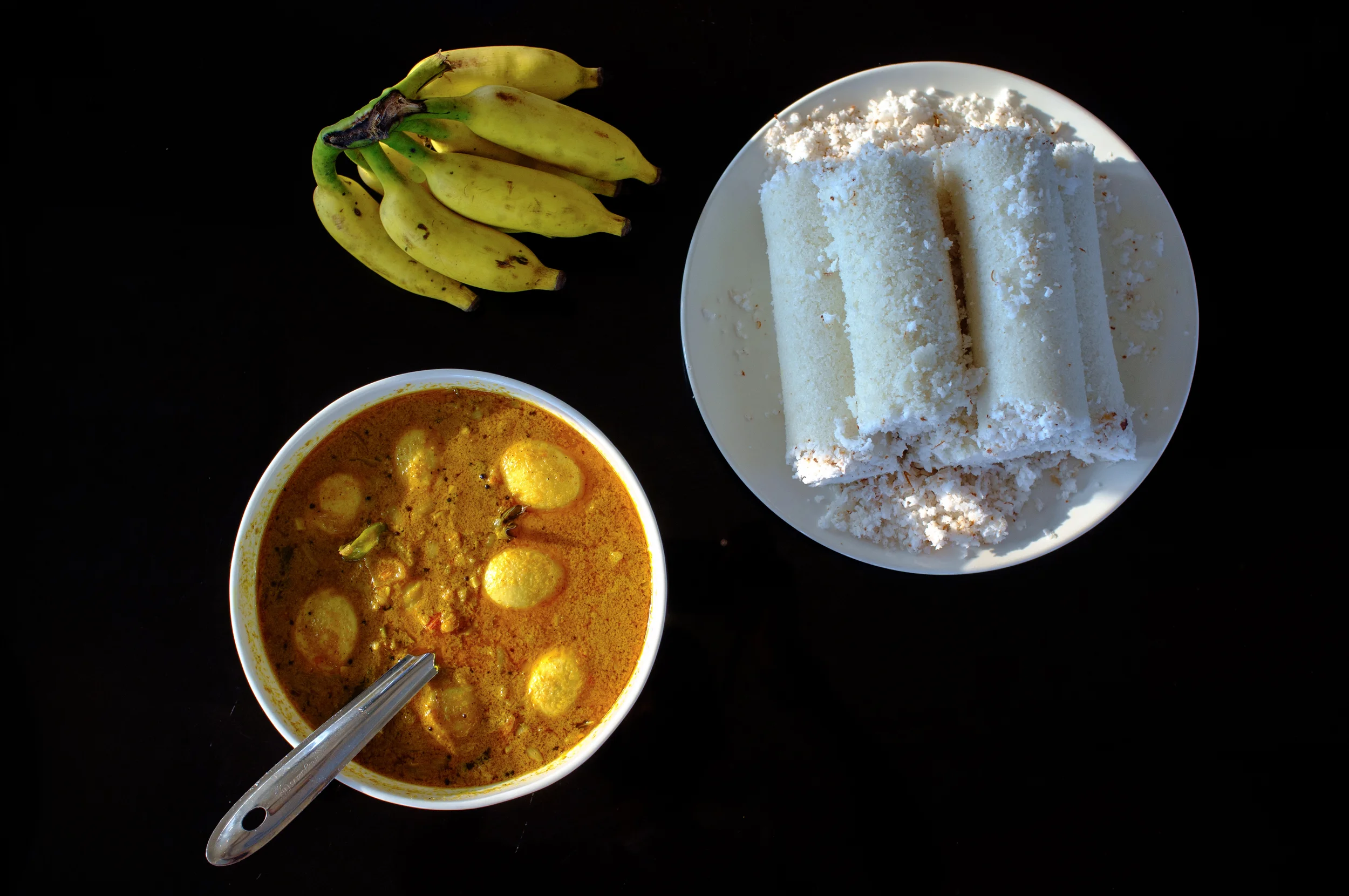 Puttu and egg masala for breakfast on a houseboat in Alappuzha, Kerala