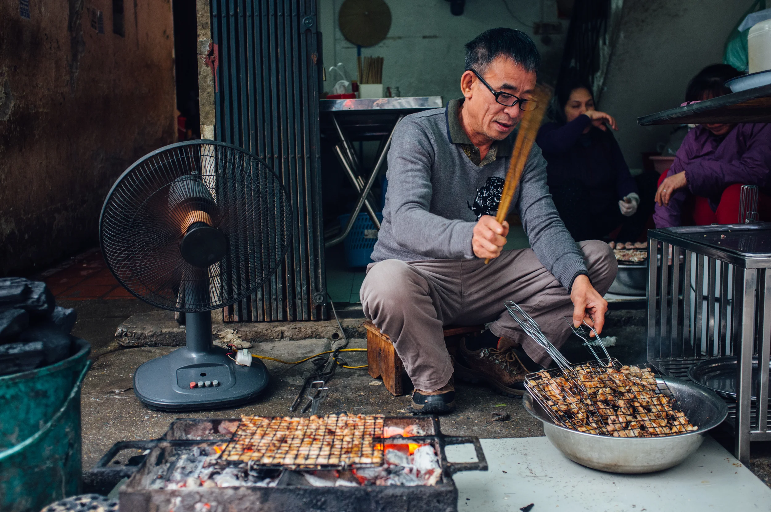 Uncle prepping bún chả on the streets of Hanoi