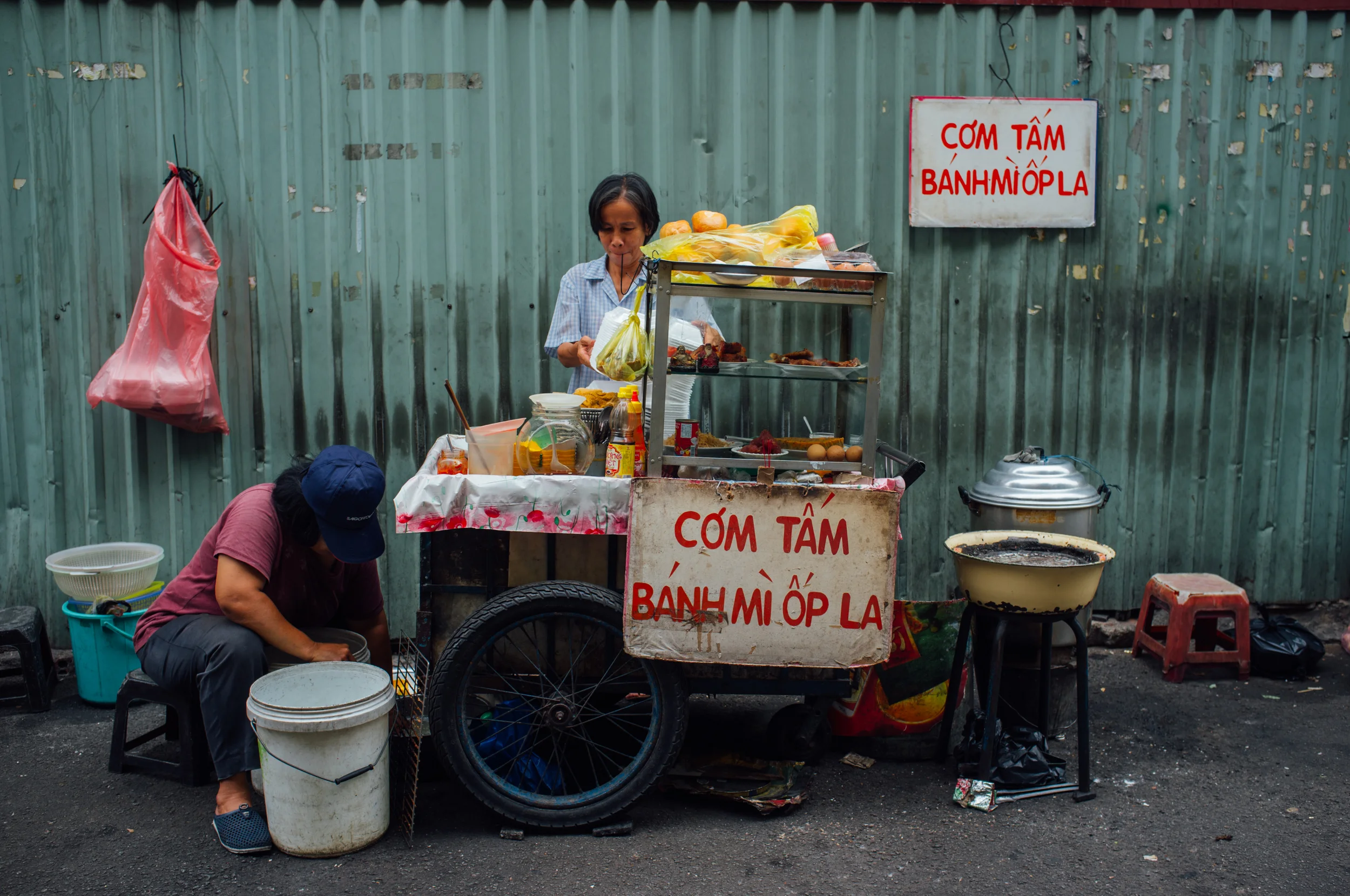 Vendor selling broken rice (cơm tấm) and fried egg sandwich (bánh mì ốp la)