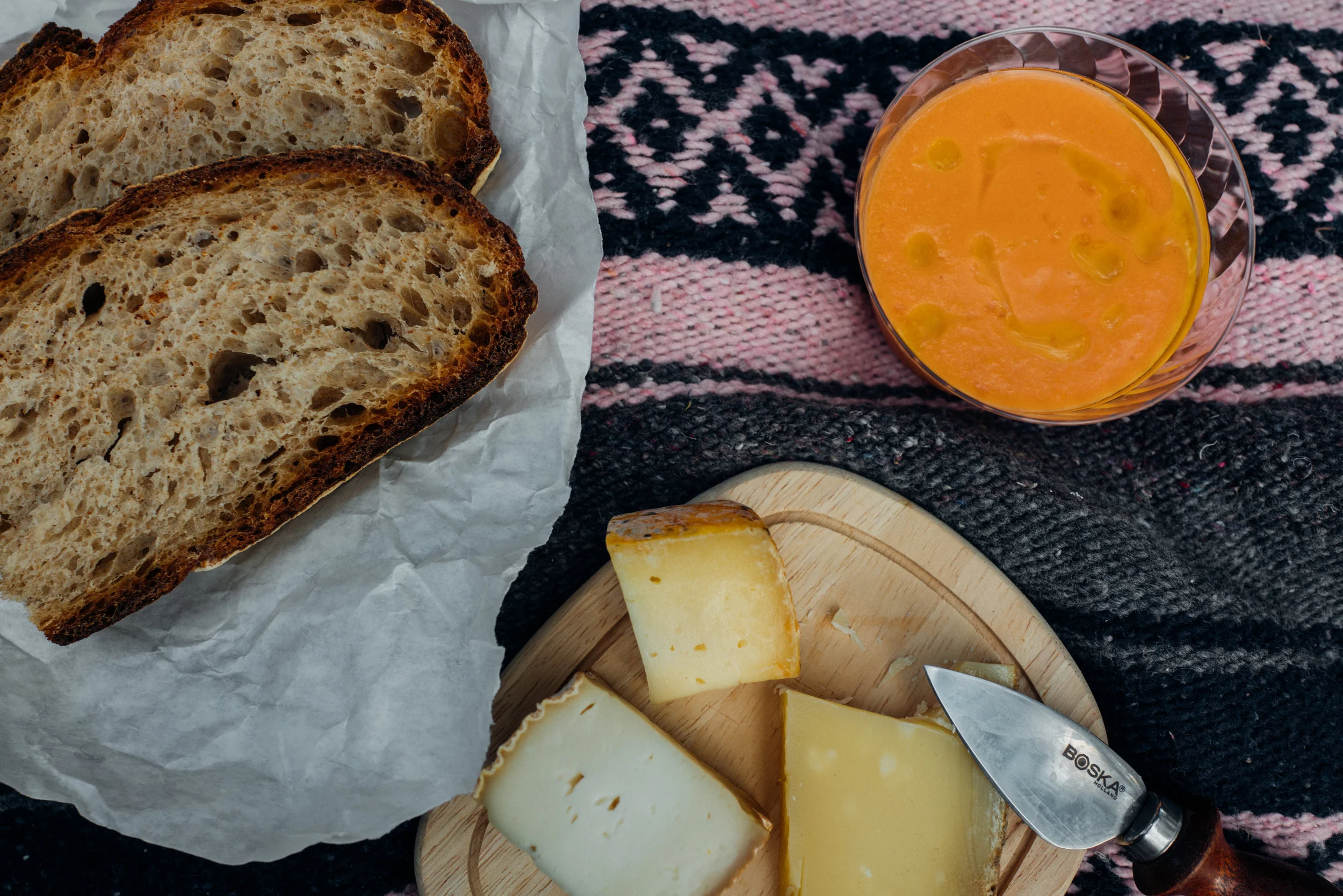 Picnic of gazpacho, sourdough bread and cheeses