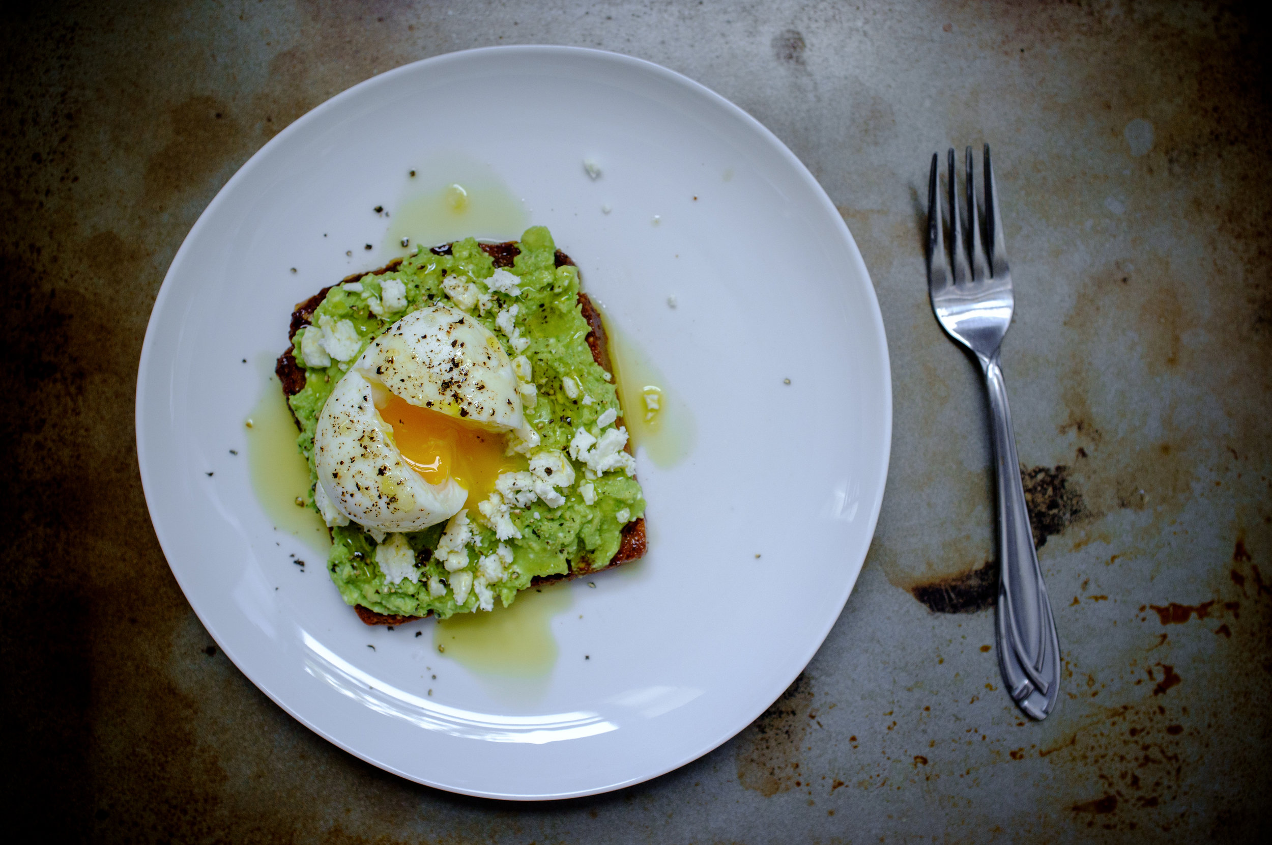 Avocado toast with feta cheese and a soft boiled egg