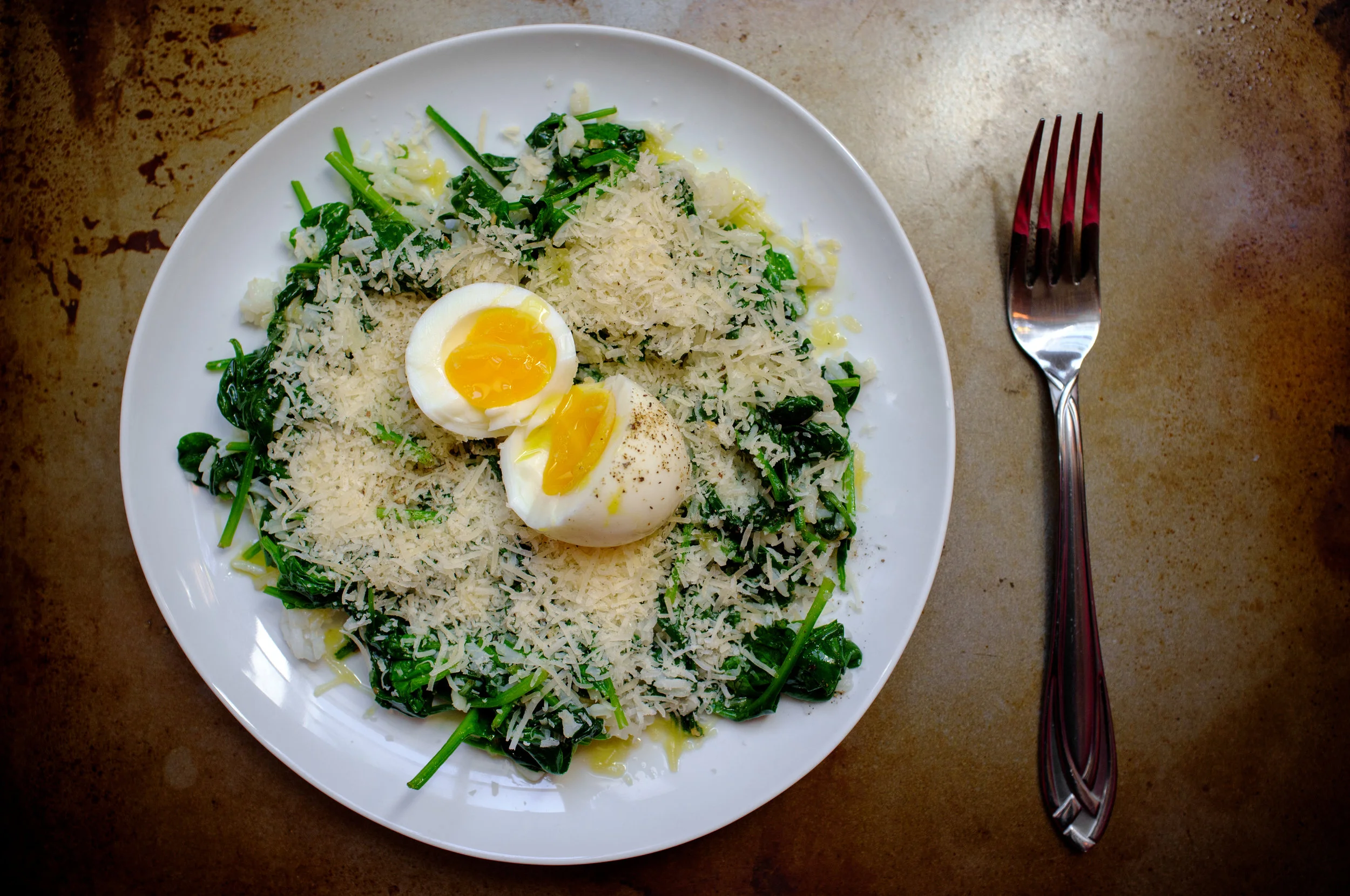 Leftover rice, sautéed spinach and cheese topped with an egg