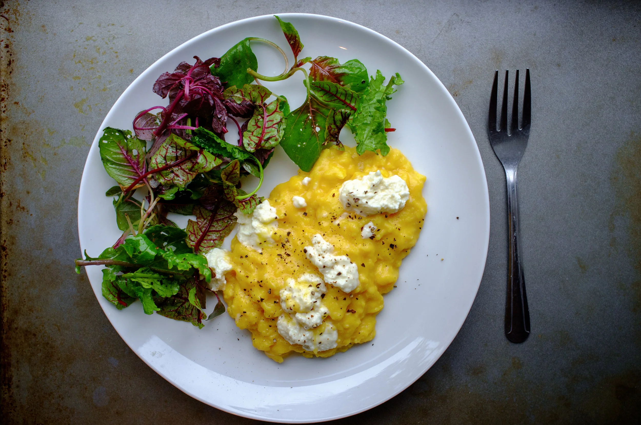 Slow scrambled eggs topped with ricotta