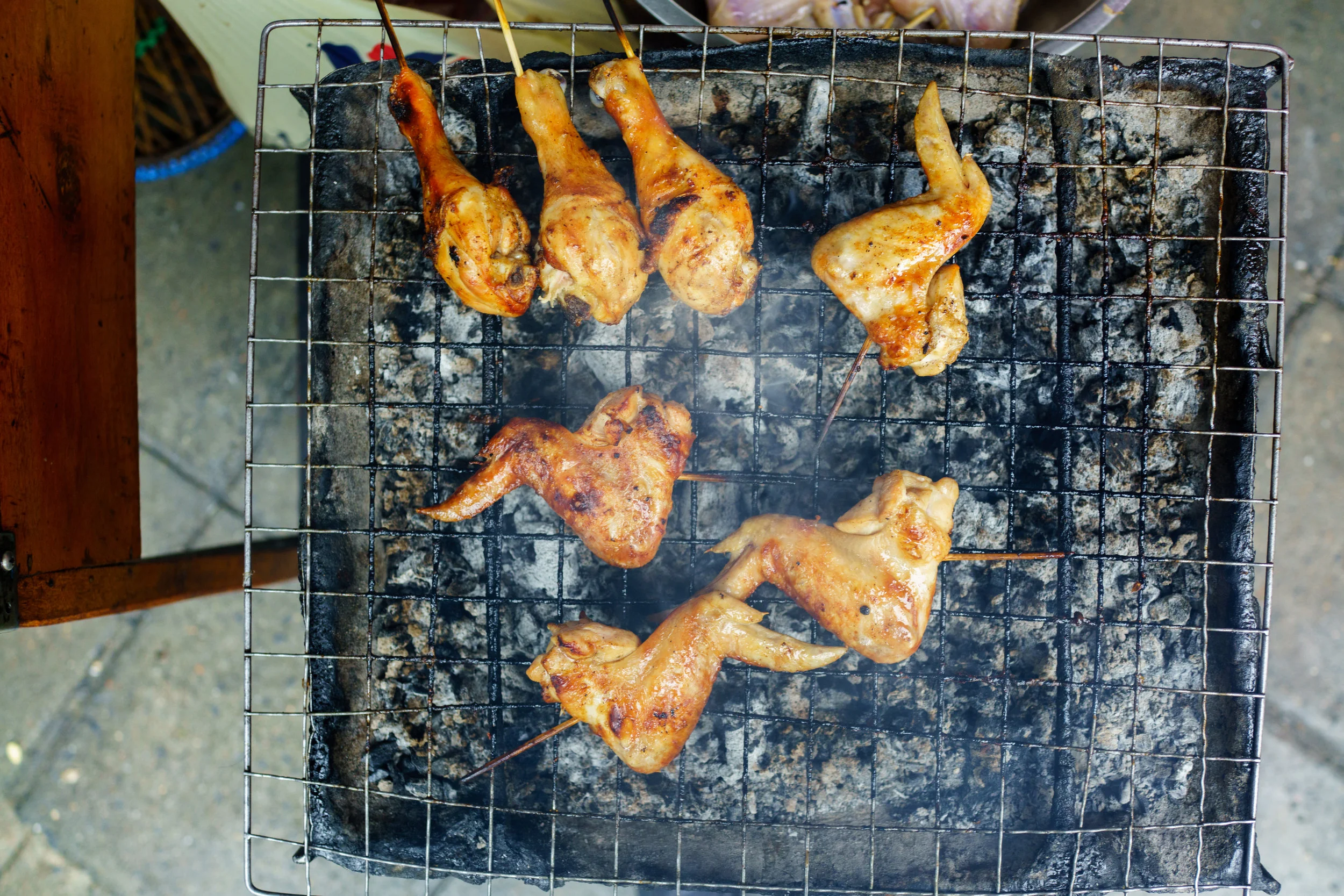 Gai yang - chicken slow-roasting over charcoal