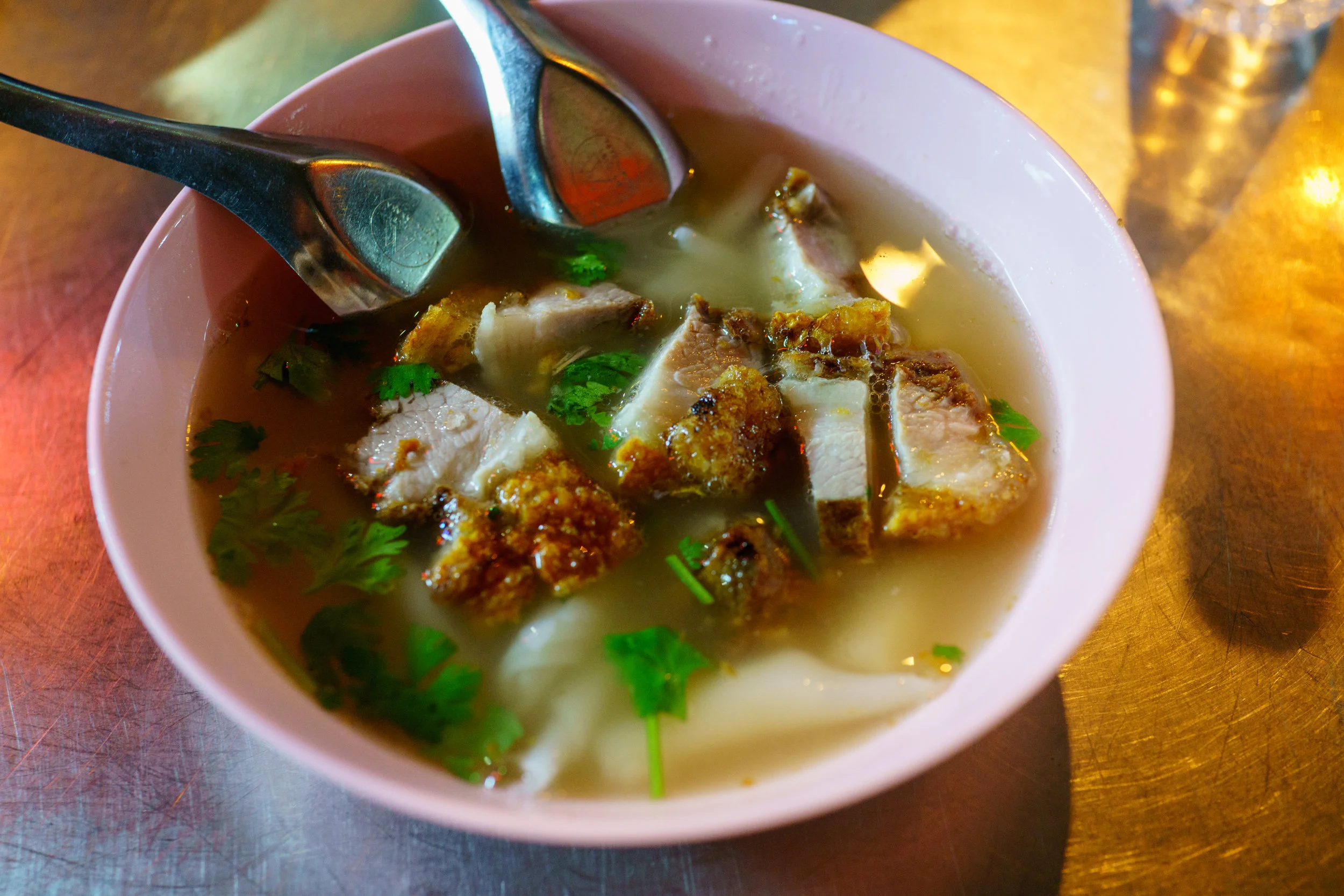 Delicious bowl of kuay jap nam sai , clear broth pork soup, in Bangkok's Chinatown