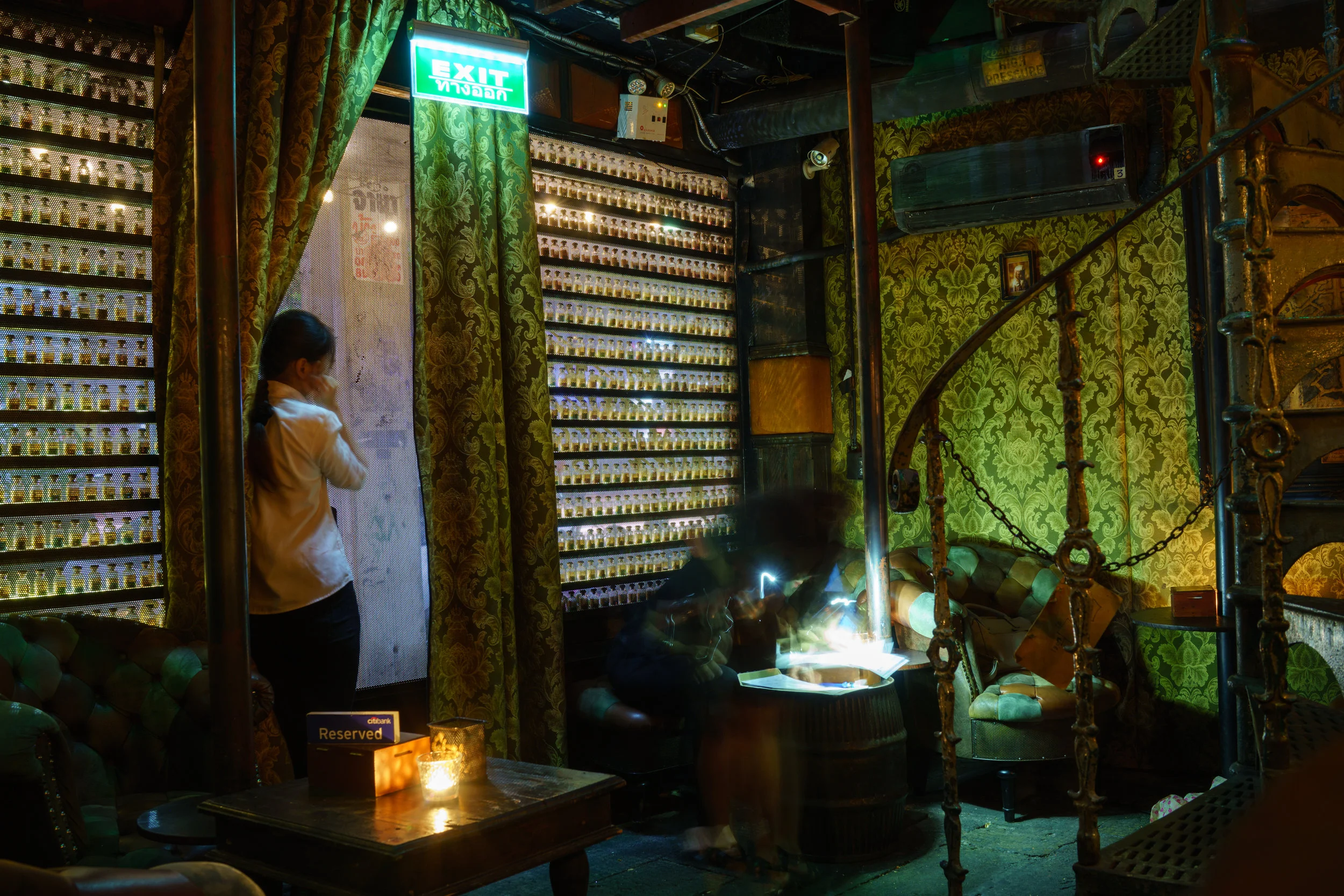 The entrance to The Iron Fairies in Bangkok is lined with small vials of fairy dust