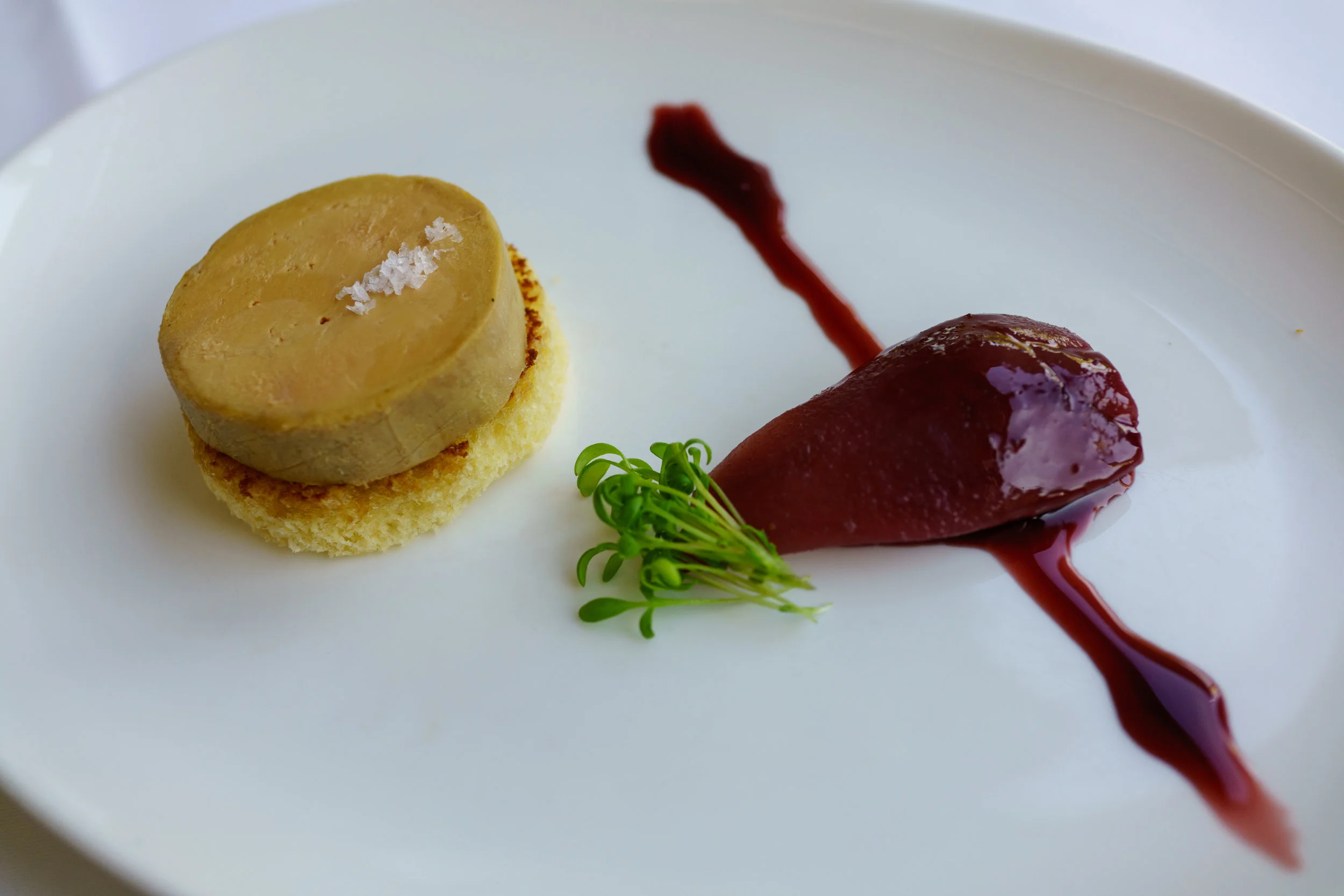 Foie gras torchon, Croatian red wine reduction, pear, and brioche at Bistro Apetit