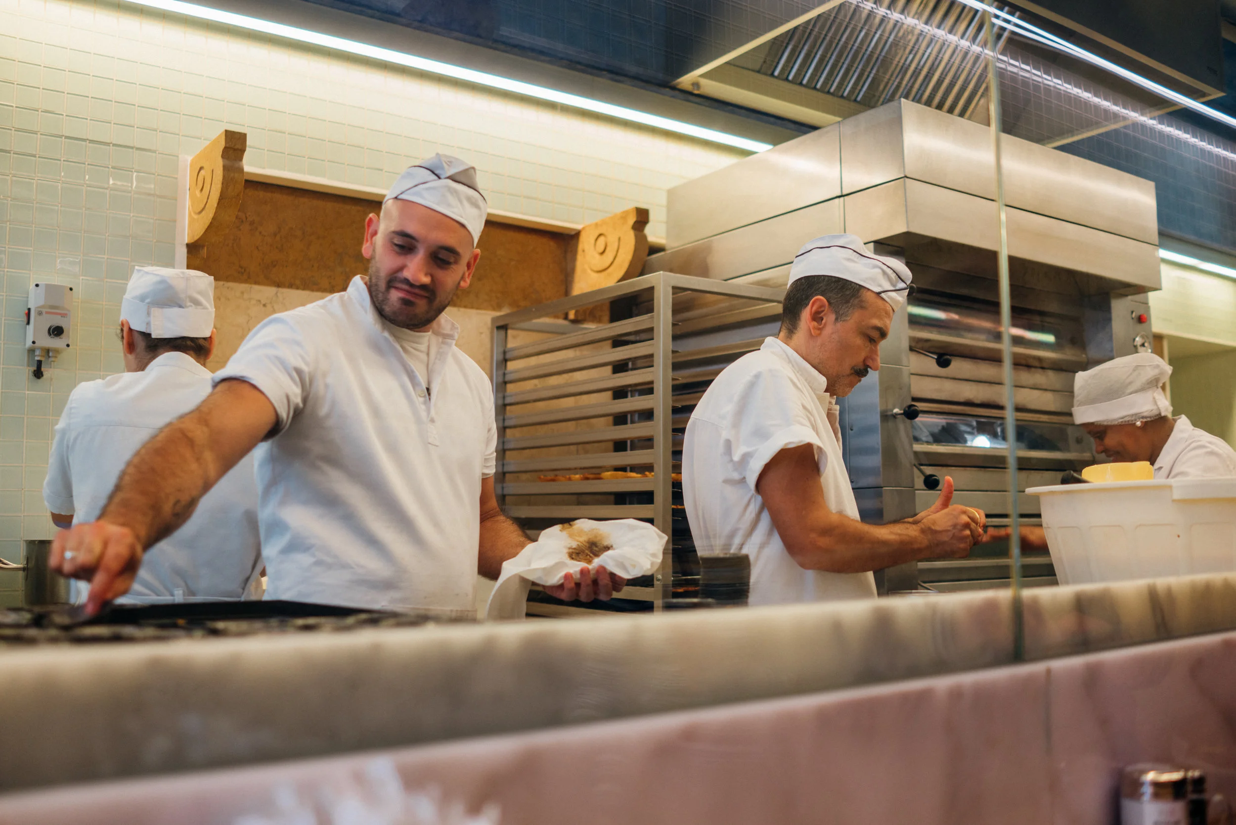 You can see the p astéis de nata being made through the glass-walled kitchen