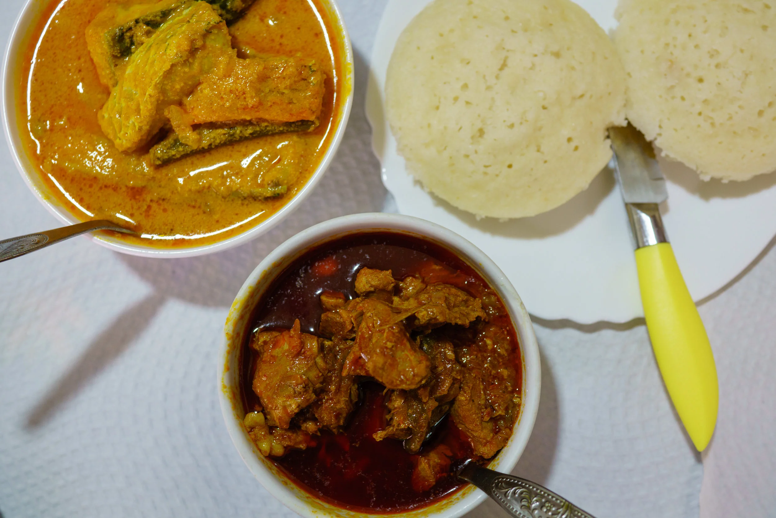 Clockwise, from top: Caril de Peixe, sannas, and sarapatel at Sabores de Goa