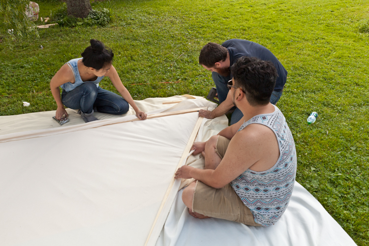 Stretching the fabric for the roof pieces.