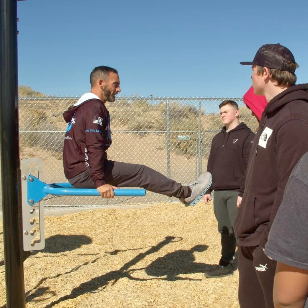  fitness instructor showing exercise on bar 