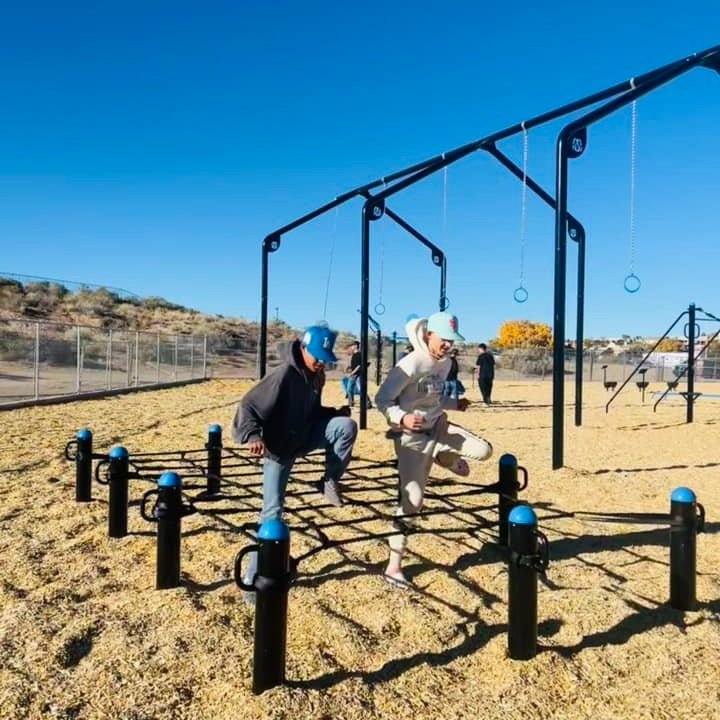  two men using agility net on floor 