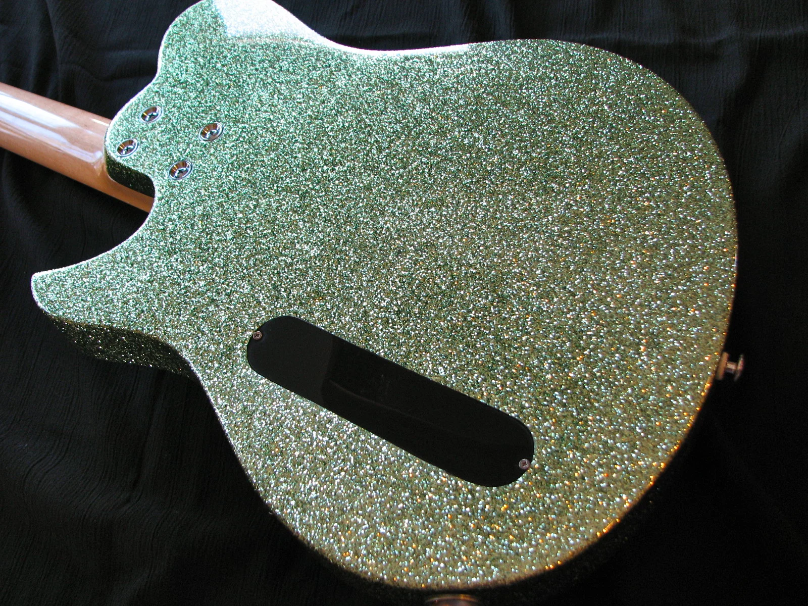 The body is alder with a lime-green sparkle finish