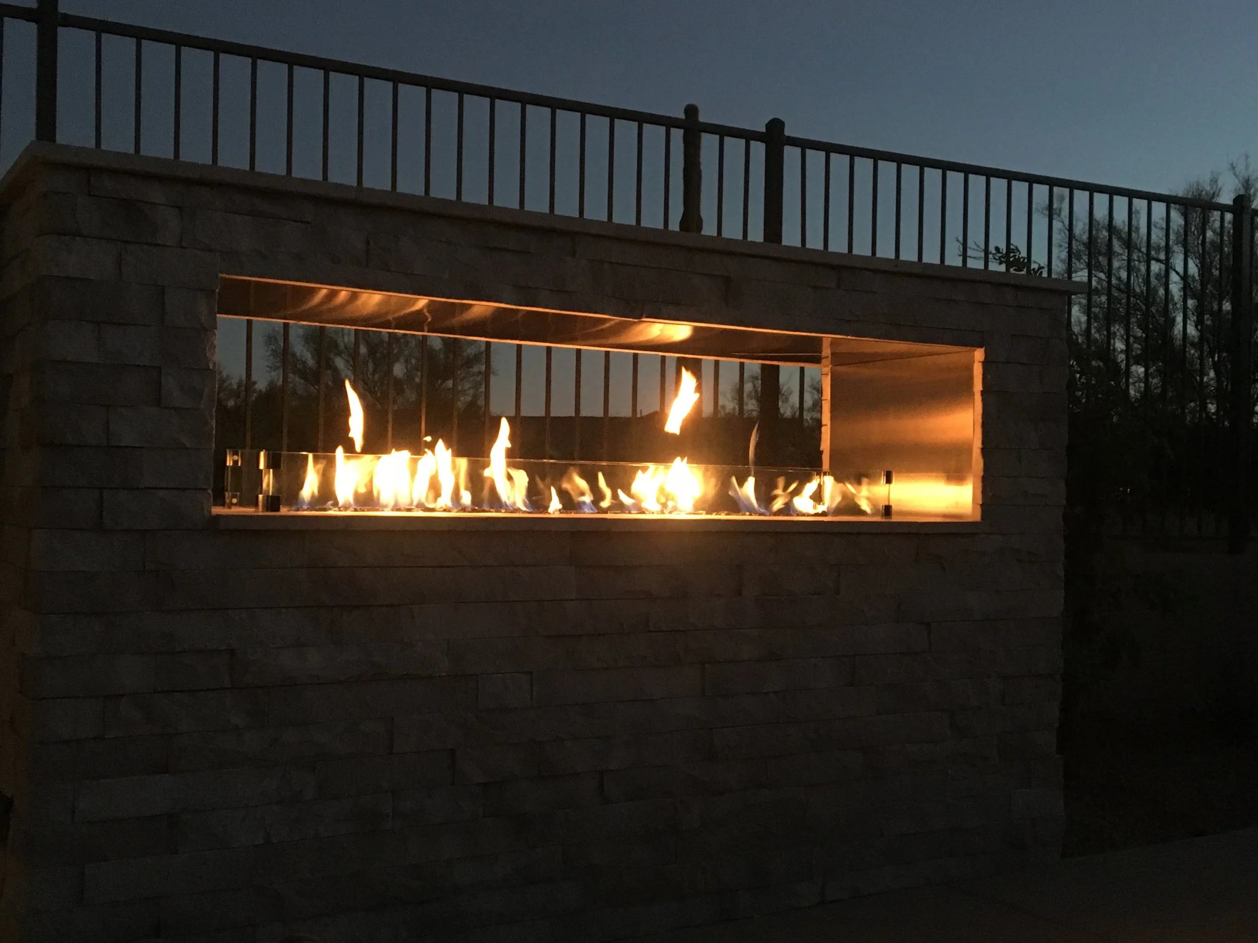 Outdoor fireplace and desert landscaping built by Blooming Valley Landscape