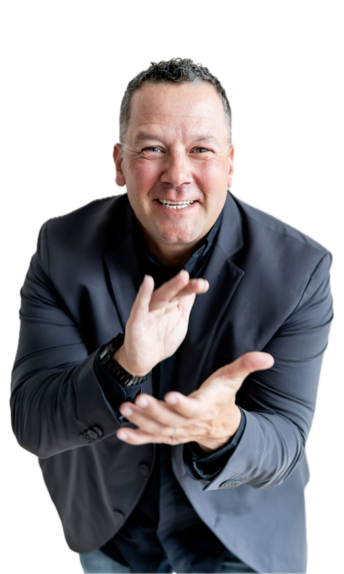 Tony Miltenberger in a dark blazer gesturing with his hand, facing the camera.