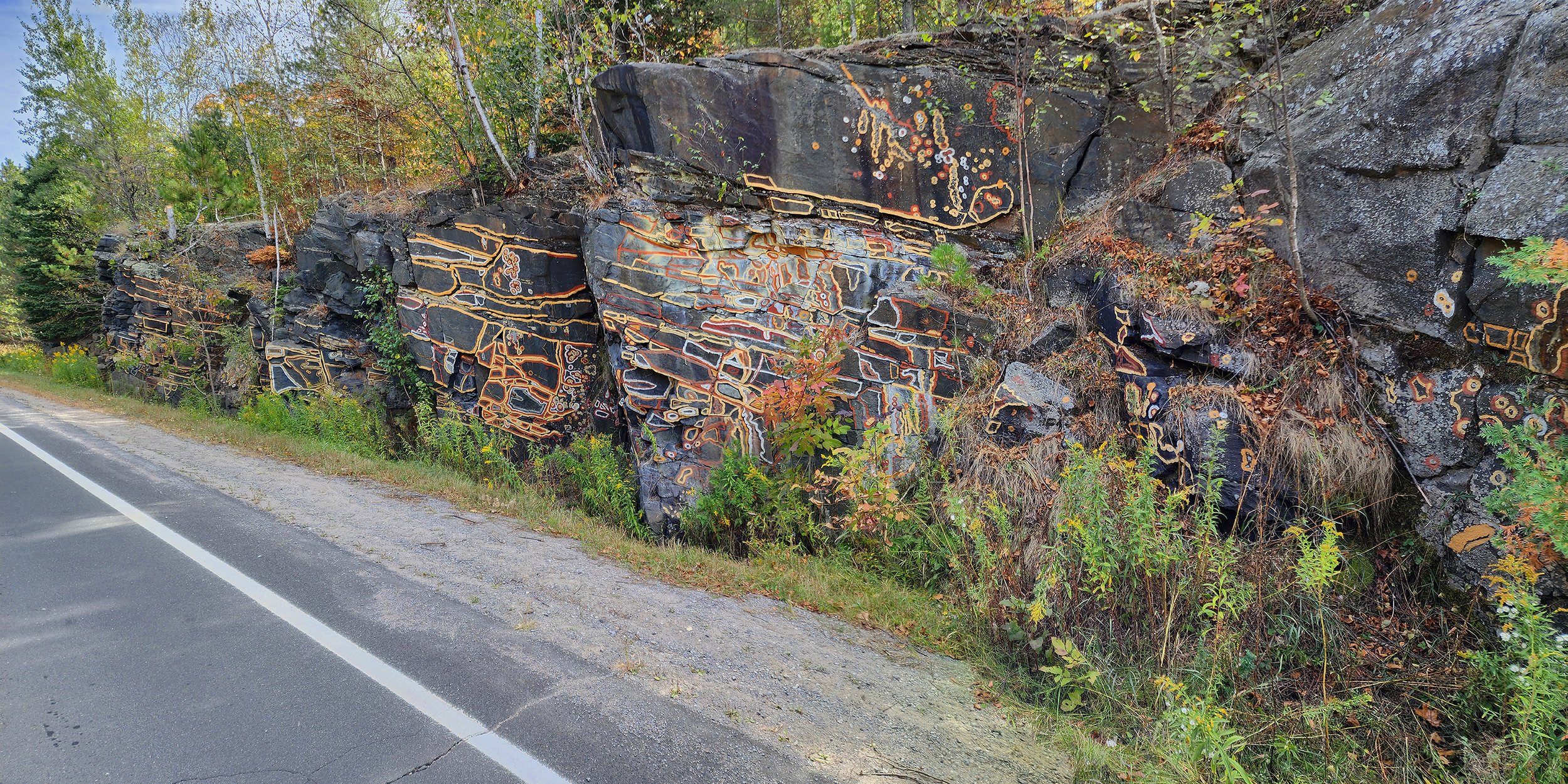   Communicating with Split, Remembering Connections,  Cole Swanson and William Kingfisher. Hand-foraged and prepared mineral colours on highwayside rock face, 2025.  