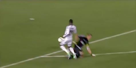 CD Chivas's Dan Kennedy fouls Vancouver Whitecaps FC's Kekuta Manneh outside the box with a late tackle at the Home Depot Center on 30 March 2013.