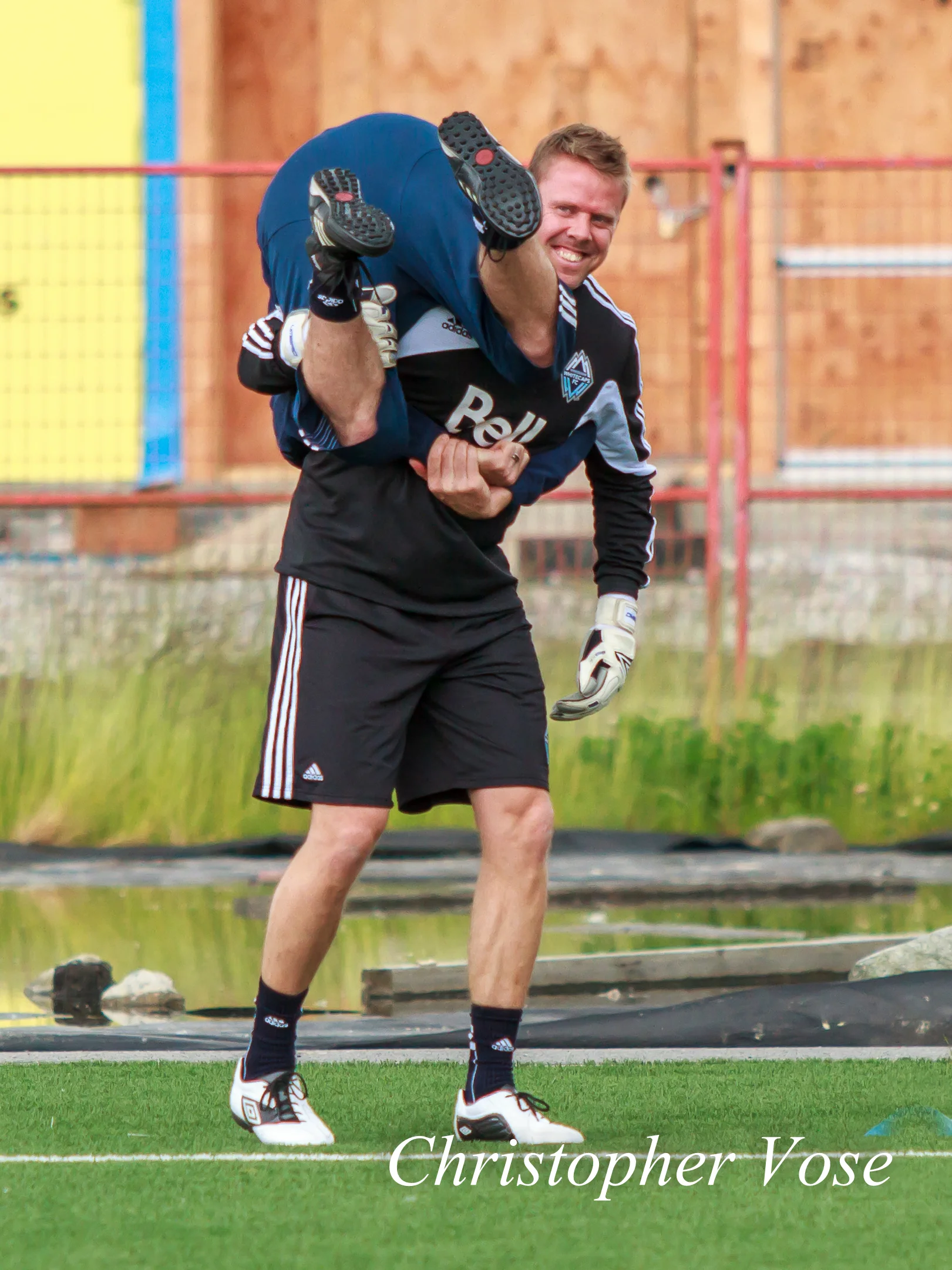 Marius Røvde prepares for his 40th birthday by carrying Vancouver Whitecaps FC physiotherapist Graeme Poole around the pitch at the Burnaby Lake Sports Complex on 14 June 2012.