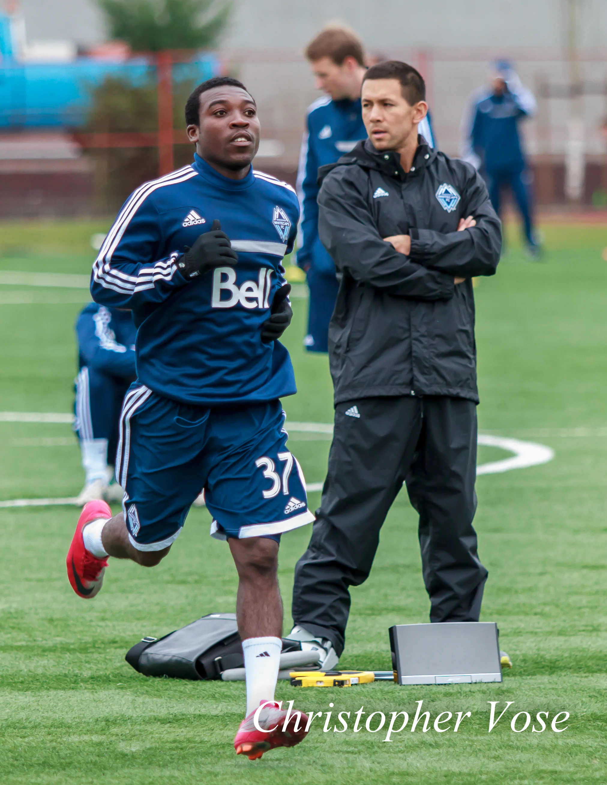Emmanuel Adjetey runs by Mike Young at the Burnaby Lake Sports Complex on 9 February 2013.