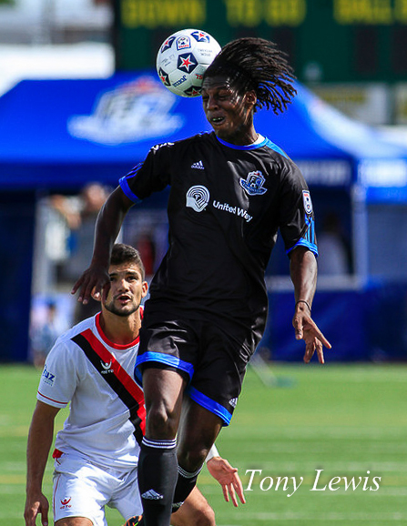 FC Edmonton's Anthony Adur leaps over Atlanta Silverbacks FC's Alberto Navarro at Clarke Stadium on 18 August 2013.