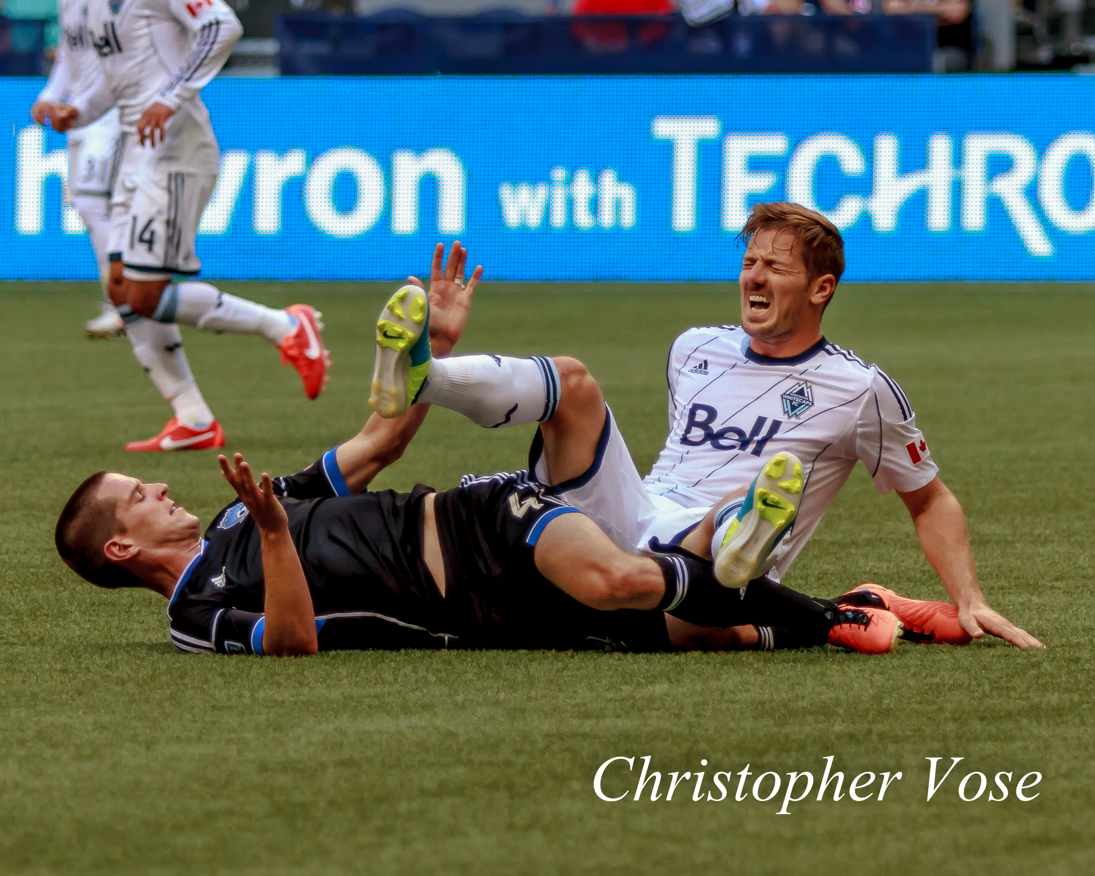 San Jose's Sam Cronin takes out Vancouver Jordan Harvey with a late tackle.