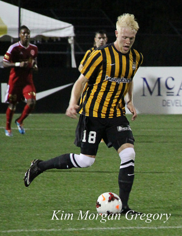 Jackson Farmer plays the ball at Battery Park on 29 March 2014.