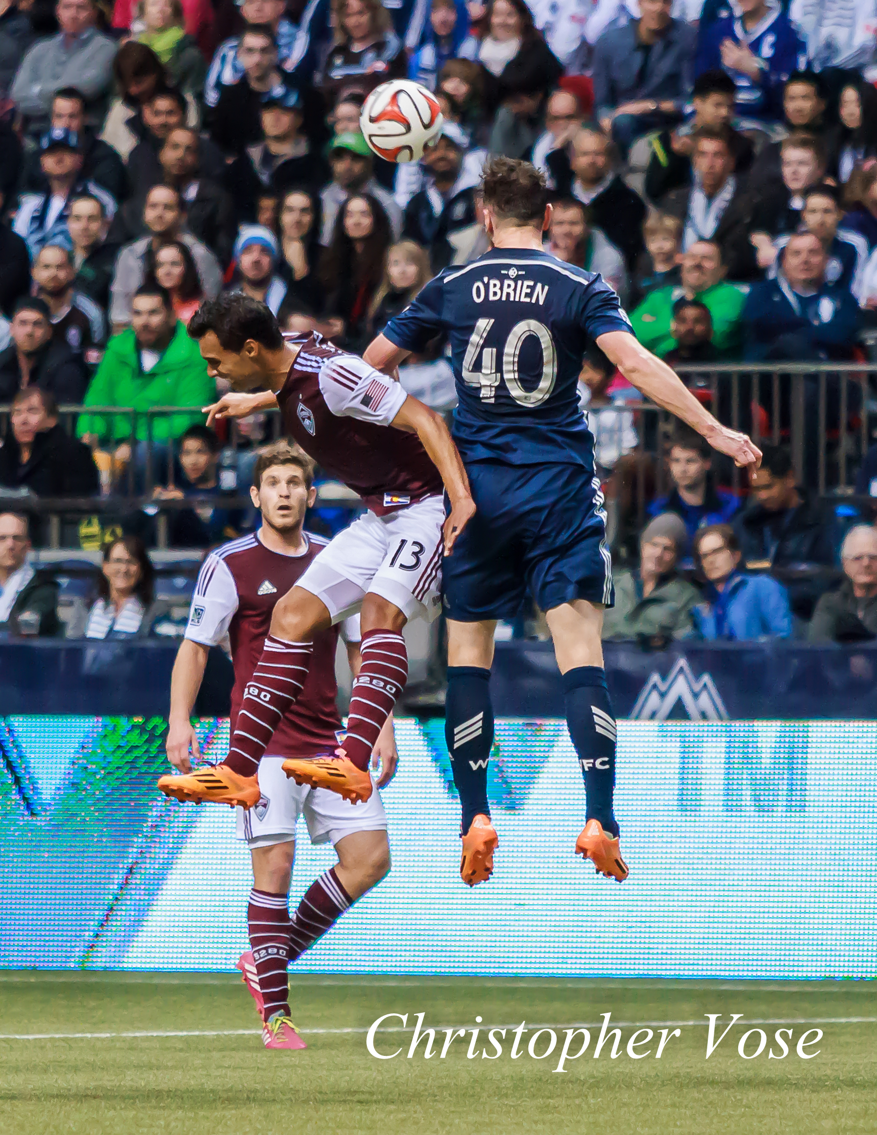 Andy O'Brien wins an aerial duel with Colorado's Kamani Hill at BC Place on 5 April 2014.