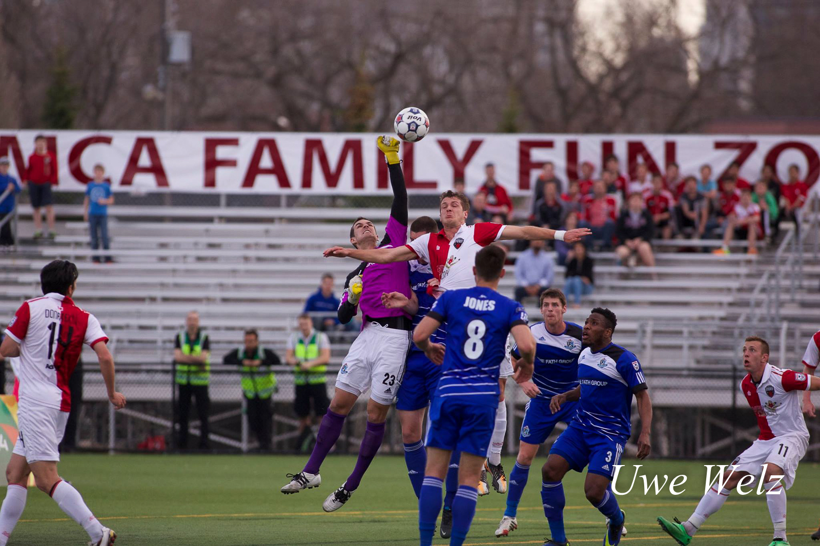 John Smits punches the ball away while under pressure from Mason Trafford.
