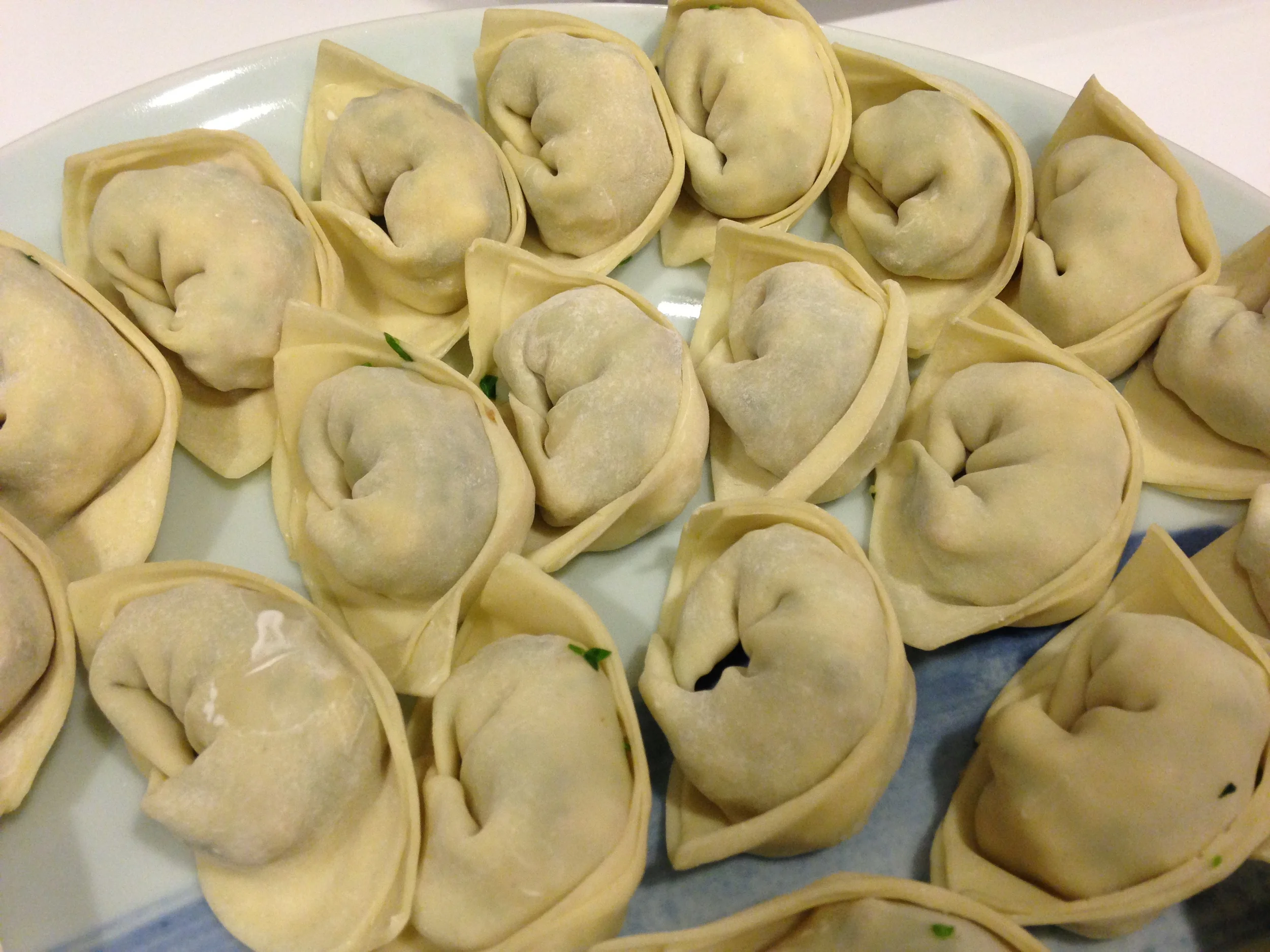 Jiaozi - This shape is best prepared in boiling water or eaten in a soup broth.