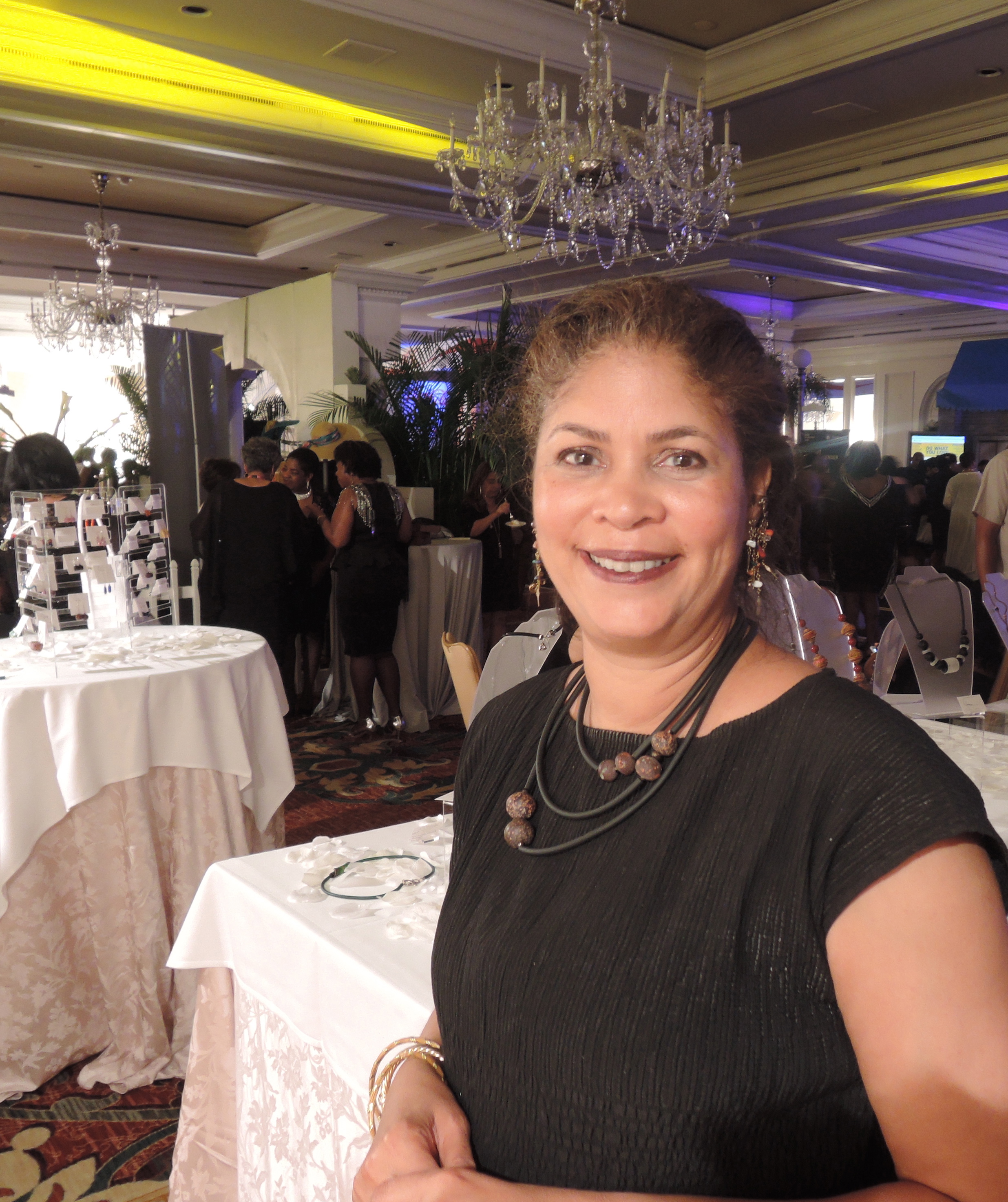 Linda Bradley, MD Prof. of Surgery and Vice Chair at the Cleveland Clinic OB/GYN & Women's Health Institute ,wearing her necklace "Space" made with basalt stone beads shaped and hand drilled over 200 years ago. The stories these beads could tell! She is in the Odyssey lounge for the evening's activities.